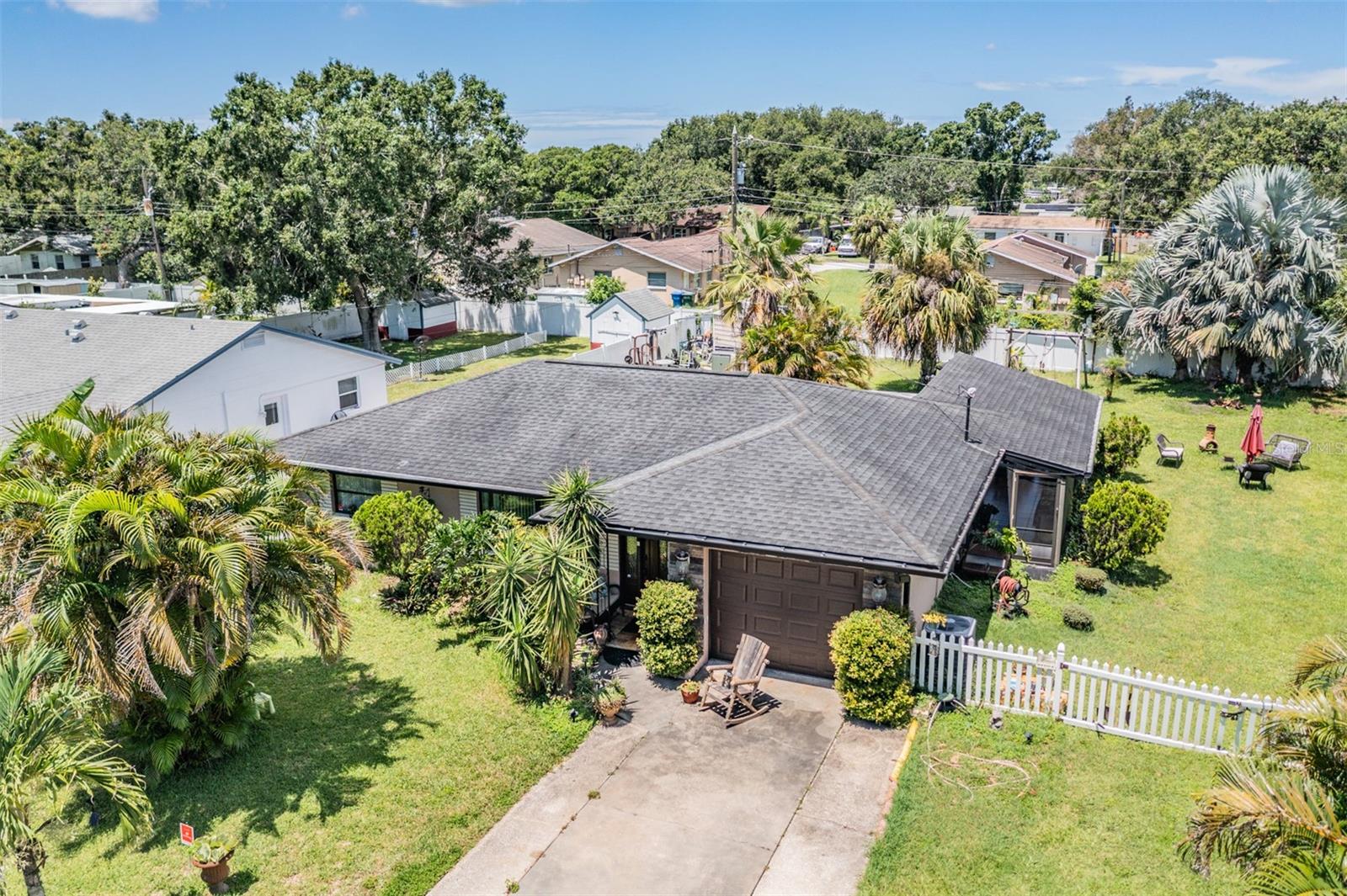 Welcome to 250 Lake Palms Drive, a charming and energy-efficient 3-bedroom, 1 full bath single-story home in the heart of Largo! This thoughtfully maintained residence combines comfort, functionality, and style, offering a seamless blend of indoor and outdoor living. Step inside to an inviting open layout featuring a spacious living room/dining room combo, warm solid wood cabinetry, and stunning stone countertops in the kitchen. Relax and unwind in the spa-like bathroom complete with a Jacuzzi tub your personal retreat after a long day. Cozy up next to the fireplace on cool evenings or enjoy Florida’s sunshine in the large, lush garden surrounded by mature landscaping. Extra storage with an outdoor shed adds convenience, and the closed-circuit security system, owned alarm, and smoke detectors provide peace of mind. Energy-conscious upgrades include additional insulation and window film for improved efficiency all year round. Located just minutes from Largo Central Park, Largo Medical Center, Highland Recreation Complex, and East Bay Shopping Plaza, this home is perfectly positioned for both relaxation and convenience. Zoned for Largo High School, Largo Middle, and Mildred Helms Elementary, and close to all your daily essentials, this property has it all. Don’t miss your chance to own this move-in ready gem with character, security, and modern comfort – schedule your private tour today!