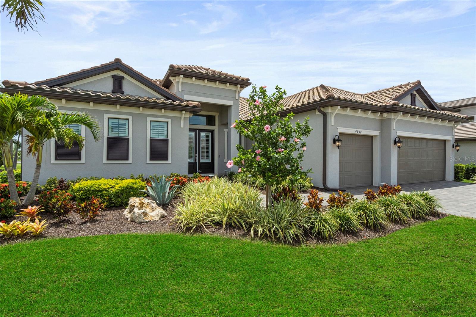 Welcome to this sought after model, the Sunset, offered in Lakewood Ranch’s highly coveted Lorraine Lakes. This fantastic, gated community with resort style amenities makes coming home feel like a vacation. This newly built home in 2022 has already been upgraded with many custom features making this home stand out above the rest. As you enter, you are greeted by double front doors and a spacious dramatic 12 ft foyer, followed by the impressive open concept floor plan of this popular Sunset model. The great room with tray ceiling and newly installed custom electric fireplace feature wall in 2024 is the perfect space to relax and unwind. The gorgeous kitchen with massive quartz island features some of the home's most impressive upgrades that include cabinets with custom edged glass cabinet tops and built in lighting. The cabinetry has been enhanced with reinforced expanded shelving, high-end hardware, and soft closing features. The appliances have all been replaced and upgraded to a higher standard than supplied by the builder. A stylish and sleek range hood and backsplash complete the fantastic kitchen upgrades. Elegant and timeless upgraded lighting on dimmer switches is featured throughout the home, adding both style and value. There are some things you can’t put a price on, and the spectacular sunset views from this oversized screened in lanai with pool and spa is one of them. This spectacular western exposure pool home with unobstructed 160-degree water views from every angle is sure to be a favorite feature. The professionally landscaped corner lot is great that you do not have any other homes on the south side of the property. Additional highlights include custom closet organizers, UV light on the HVAC, 10 ft ceiling height in the main living area, plantation shutters, private primary suite bath with customized shower including a rain dump, privacy SPF sun control motorized roller shades on the back lanai, 3 car garage with epoxy garage floor, professionally landscaped yard with an array of tropical palm trees showcased by the landscape mood lighting, and a gas line for the outdoor grill. Lakewood Ranch is recognized as the number one selling master planned community, and Lorraine Lakes helps set the standards to make that recognition possible. The HOA benefits include lawn maintenance, irrigation, cable, internet, 3 entrances, many common areas, gate guard, and 24-hour security. The amazing resort style town center features amenities including a full-service restaurant, tiki bar, arcade, gym, fitness center, saunas, pickle ball, tennis, volleyball, resort pool, lap pool, and splash pad to name a few. Lorraine Lakes flourishes with walking paths and lovely lakes including the main pond with dock, and fishing is permitted. Important to note, the builder has completed selling out the estate series homes making this a rare and valuable find. This home conveyed for 1.025M in Feb of 2024, the sellers have made condition improvements and price concessions to be competitive in the current market. Schedule your showing today!