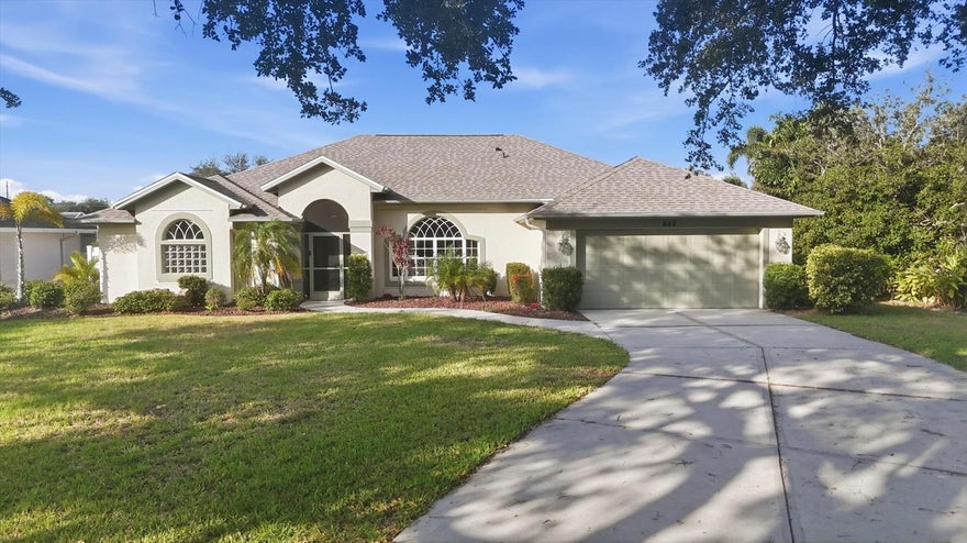 TRUE FLORIDA LIFESTYLE | WATERFRONT POOL HOME | OVERSIZED LOT — The true Florida lifestyle is waiting in this beautifully maintained Joshua C. Johnson built Savannah II model nestled beneath towering oak trees and surrounded by lush tropical landscaping on an oversized lot along the Rotonda River. From the moment you arrive, the impressive 80-foot driveway, beautiful landscaping, and charming screened front porch create the perfect welcome. Inside, this light and bright open floor plan offers spacious living with vaulted ceilings, formal dining, a breakfast nook with aquarium windows and a fixed picture window, and multiple sliders throughout—including triple sliders in the living room—that seamlessly open to the expansive lanai and allow the irresistible Florida breeze to flow throughout the home. The beautifully updated kitchen features granite countertops, stainless steel appliances, a farmhouse sink, abundant cabinetry, and overlooks the sparkling pool and waterfront views. The oversized screened lanai and pool area were designed for entertaining and relaxing, complete with a pool bath, outdoor refrigerator, TV area, multiple sitting spaces, and plenty of room to float the days away in your refreshing pool while enjoying peaceful canal views and abundant wildlife. The private backyard is lined with Areca palms for added privacy and offers room to add a dock for even more waterfront enjoyment. The spacious primary suite features his-and-her closets and tranquil backyard views, while the large laundry room includes extensive cabinetry and a dedicated space for a wine fridge. Additional highlights include hurricane fabric panels for easy setup and storage, hurricane shutters, a paver walkway leading to the fenced backyard, a 2-car garage with utility sink, exterior repainted in November 2021, new roof in 2022, and a new A/C system in 2016. This exceptional waterfront retreat is move-in ready and perfectly suited for full-time living or your dream Florida getaway.