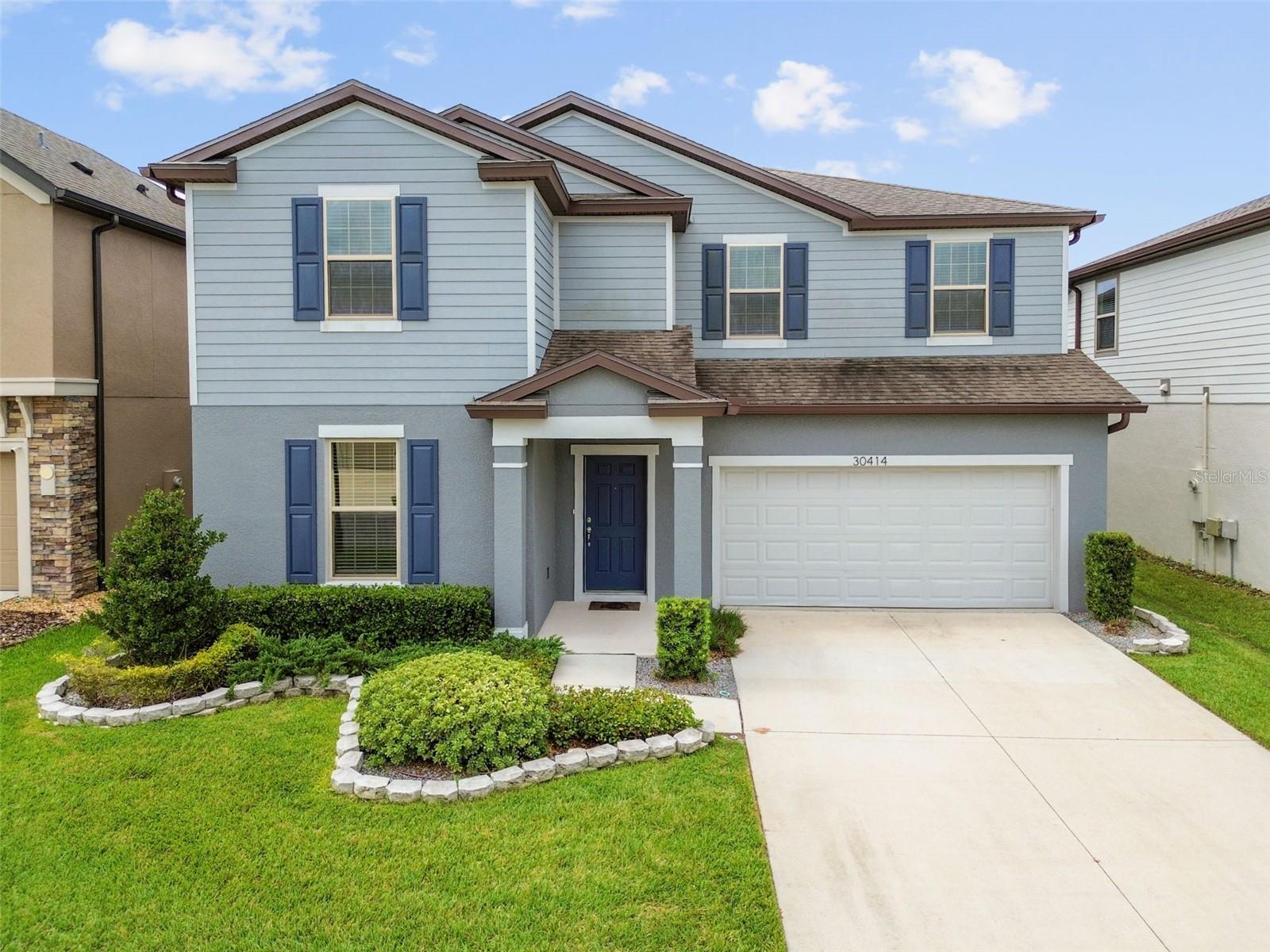 Welcome to 30414 Caravelle Ln, a one-of-a-kind home in the highly desirable gated community of Wesbridge! Boasting over 3,200 square feet of living space, this thoughtfully designed floorplan is the only one of its kind in Wesbridge, offering exceptional versatility and comfort for today’s lifestyle. Step inside to find NEW luxury vinyl plank flooring on the main level and brand new carpet upstairs. The spacious layout includes multiple living areas downstairs, perfect for entertaining or everyday living, plus a large loft upstairs that provides additional space for a game room, home office, or media area. The primary suite is truly a retreat, generously sized with a private sitting area ideal for reading, relaxing, or creating a quiet workspace. The heart of the home, the kitchen, features quartz countertops, abundant cabinetry, and a huge walk-in pantry with a nearby nook ideal for a custom butler’s pantry setup. Storage is plentiful throughout the home, with options on both floors, and the dual HVAC systems ensure year-round comfort. Outside, enjoy the landscaped border, and with the simple addition of gates, the backyard will be fully fenced in, ready for pets, play, or privacy. Wesbridge residents enjoy resort-style amenities including a sparkling pool, playground, and other amenities, all just steps from the community's zoned schools. If you're looking for space, style, and location, this home checks every box. Don’t miss your chance to own this rare gem in Wesbridge!
