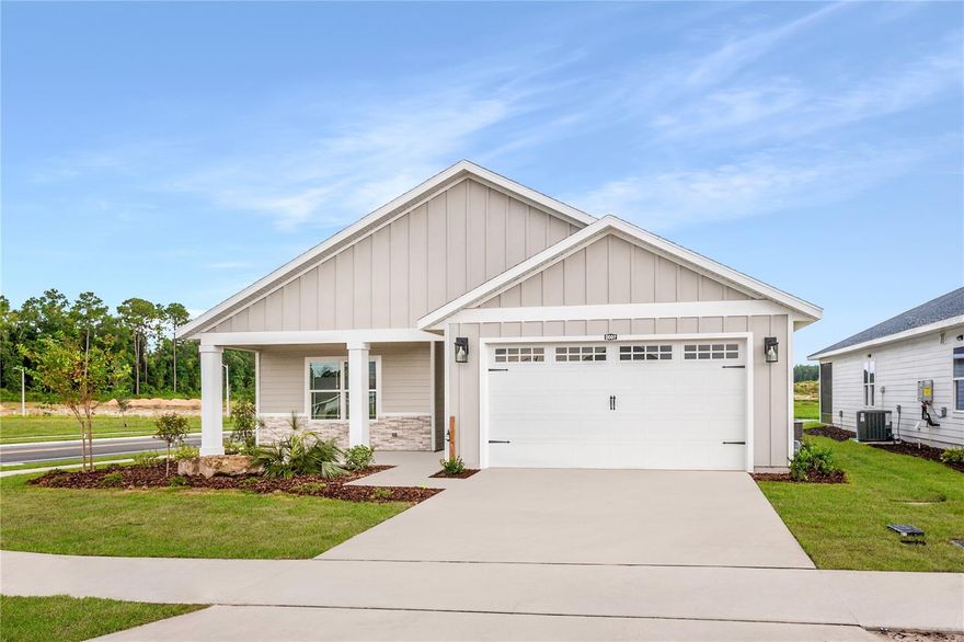 Pre-Construction. To be built. Set in Tanglewood in Newberry, FL, The Clover Grande by William Weseman Construction puts you in the middle of what makes this part of Alachua County so appealing: the small-town charm of Newberry and the conveniences of Jonesville and Gainesville. Built by a 3rd-generation local builder, this new construction home blends practical design, durable materials, and polished finishes. This 4-bedroom, 3-bath plan offers 2,161 heated and cooled sq ft, an expansive take on the popular Clover layout, with a true 3-way split-bedroom design and more room throughout. The main living area centers around a generous open great room where kitchen, dining, and living flow together into a bright central gathering space. The kitchen is anchored by an oversized center island and includes quartz countertops, solid wood cabinets with soft-close drawers, tile backsplash, pull-out dual trash bins, and a stainless steel under-mount single-basin sink. A corner pantry and abundant cabinetry offer excellent storage, and included appliances are a stainless steel slide-in electric range, microwave, and dishwasher. The primary suite is privately located at the rear of the home with generous proportions, a triple window, an expansive walk-in closet, and a bathroom with dual sinks, a full tile shower, and a private water closet. Two additional bedrooms and a full bathroom with tub are situated in a separate wing, while the fourth bedroom includes its own full bathroom and walk-in closet, ideal for guests, extended family, or multigenerational living. The laundry room includes a utility sink. Step outside through the 8'x8' glass slider to the rear porch, extending the generous feel of the home outdoors. Additional interior highlights include LVP flooring throughout, ceramic tile in bathrooms, 9' ceilings, recessed LED lighting, and ceiling fans. Exterior details include stacked stone accents, Hardie board siding with spacer clips and board-and-batten accents, 12"x12" columns, low-maintenance aluminum soffits, a fully sodded Zoysia yard, and a 2-car garage with an 8' door. Energy-smart features include Low-E windows, R-30 insulation, 15 SEER HVAC, electric water heater, and wi-fi enabled thermostat and garage door opener. Buying at this stage offers buyer design selections and personalization, with choices and upgrades available including roof shingle color, exterior paint color, stone accent color, cabinet color, countertops, interior paint color, front door, and interior door style. Tanglewood's planned amenities include a pool, playground, pickleball, covered pavilion, and sidewalks on both sides of the street. The $95/month HOA includes access to future amenities plus front yard mowing and maintenance. Community services include Clay Electric, the City of Newberry, and Cox Cable. Zoned for Newberry Elementary, Oak View Middle, and Newberry High School (buyers should verify school zoning). The location offers convenient access to daily essentials and area destinations: 2.5 miles to Publix, 5 miles to area schools, 5 miles to Tioga Town Center, 9 miles to I-75, 13 miles to UF, 9.3 miles to HCA Florida North Florida Hospital, and 15 miles to the VA Hospital and UF Shands Hospital. Estimated completion: Sept 2026. Lot 81 is a 55'x114' homesite. Photos are of a previously completed similar home; finishes and selections may vary. Ask us for availability, construction updates, and current selections list.
