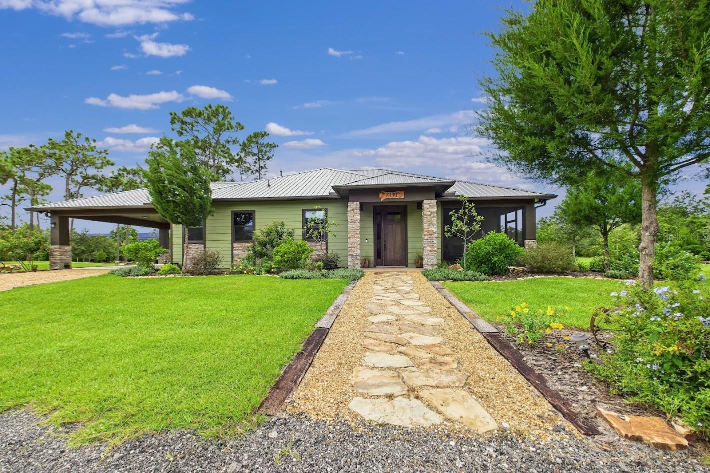 This CBS 2BR/2BA custom home sits on 5 acres featuring a peaceful pond, private island, waterfall, and land bridges. Finished using beetle-kill pine harvested from the property—also crafted into one-of-a-kind furniture—it blends rustic charm with thoughtful design. Accessibility was prioritized, with a primary bath and a deep soaking tub in the guest bath. Triple sliding doors invite the outdoors in, offering serene views. The kitchen and bathrooms feature granite counters and knotty pine accents. An oversized utility room includes a built-in dog wash. The property boasts a 40x60 pole barn, two RV hookups, and room to grow. Surrounded by over 300 trees, it offers privacy and frequent wildlife sightings. Located at the end of a quiet road in an agricultural zone with no HOA, and bordering a Wildlife Management Area—enjoy total tranquility while still being close to the Space Coast, Orlando Airport, Theme Parks, and Beaches.