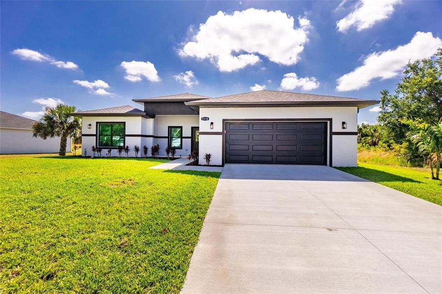Brand New Construction!  Stunning new construction home offering 4 bedrooms and 3 bathrooms with a sleek, modern design that stands out from the moment you arrive. The striking two-tone stucco exterior, lush fresh landscaping, and oversized two-car garage create undeniable curb appeal under the beautiful Southwest Florida sky.
Step inside to a breathtaking open concept great room where soaring ceilings, recessed lighting, and large format porcelain tile flooring set an upscale tone throughout. The chef inspired kitchen is the true heart of this home, featuring an oversized waterfall quartz island with a dramatic fluted base, shaker cabinetry extending to the ceiling, a designer tile backsplash, stainless steel appliances, and a bold pendant light fixture that ties the space together beautifully. Sliding glass doors flood the living area with natural light and open to the backyard perfect for the Florida indoor outdoor lifestyle.
With four generously sized bedrooms, three full bathrooms, and quality finishes at every turn, this home is ideal for families, investors, or anyone seeking move-in-ready new construction without the wait. No HOA. Located just minutes from Gulf beaches, shopping, dining, and the best of Charlotte County.
This is the one. schedule your private showing today!