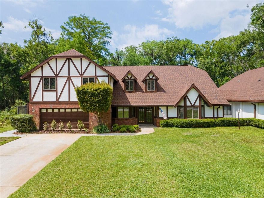 Discover refined living and rare amenities in this stunning 5-bedroom, 4.5-bath Tudor-style home nestled on 2 acres in the exclusive Hidden Lake community. Designed for comfort and sophistication, this residence features two primary suites, perfect for extended family or guests. Step inside and be greeted by soaring ceilings, rich finishes, and gracious spaces that flow effortlessly from one to the next. The enormous chef’s kitchen is the heart of the home — a dream for culinary enthusiasts — adorned with dramatic Brazilian quartzite countertops, custom cabinetry, and top-of-the-line appliances.  The oversized island, peninsula and side bar offer the ultimate in storage and custom features including a wine rack, appliance lifts and plate holder. A brick clad, wood-burning fireplace anchors the far wall. The entire space breathes a lived-in elegance—practical yet intimate—a room designed for both the quiet ritual of morning coffee and the convivial bustle of friends gathered around the peninsula.  Then enter the generous dining and gathering areas that invite conversation and connection. Beyond the glass doors lies a private outdoor sanctuary. The sparkling pool shimmers beneath the canopy of blue skies, surrounded by manicured landscaping and covered space for lounging or entertaining. Whether hosting summer soirées or quiet evenings under the stars, this residence embodies indoor–outdoor living at its best. The property includes its own airplane hangar, making it a dream for aviation enthusiasts.  Hangar has attic storage and recreation room. Hidden Lake Airport (FA40) has an asphalt runway 4,425' x 50', allowing many types of aircraft to use the facility. PAPI and full runway lighting allows night operations, the runway is open 24/7. 100LL fuel available for purchase 24 hrs/day. The roads in Hidden Lake East also serve as active taxiways, allowing pilots to taxi their aircraft directly to the hangar at their home. Garage currently used as sixth bedroom, can be easily converted back.  Approx 4,500 sq ft heated per floor plan. All information believed to be accurate and should be verified by buyer & buyers agent. Being sold "as is" for sellers convenience