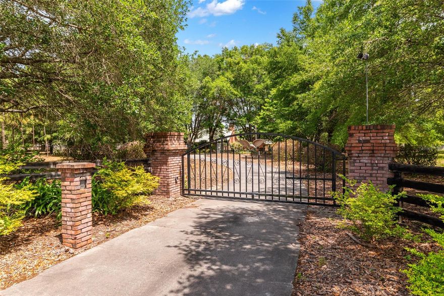 If you’re looking for something with real character and long-term value, this property delivers in a way most homes simply can’t. The all-brick construction is the standout feature here—built with a level of craftsmanship that’s incredibly rare today and not something you can easily recreate.

Inside, the home has a warm, natural feel with a mix of quality wood finishes and inviting living spaces. The main living area is anchored by a statement fireplace and designed to be both comfortable and functional, with plenty of room to spread out or entertain. The kitchen offers solid finishes and flows well into the main spaces, making it practical for everyday living.

The layout gives you flexibility, whether you need extra room for family, guests, or a separate living setup. There’s also great indoor-outdoor flow, with covered areas to enjoy the backyard and pool without being exposed to the elements.

Beyond the home itself, this property really starts to separate from the competition. Multiple outbuildings provide serious space for work, storage, hobbies, or future use. Whether you need a workshop, additional garage space, or just want room to grow into, it’s already here.

Set up with privacy in mind, the property is gated and thoughtfully laid out, with portions of the land offering both seclusion and potential tax advantages.

This is the kind of property that doesn’t come around often—solid construction, usable land, and the flexibility to make it whatever you want it to be over time.