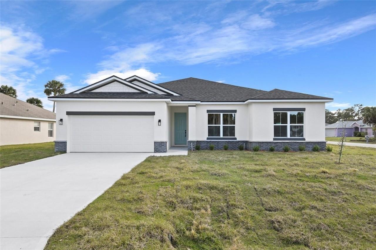 **SELLER IS MOTIVATED** BACK ON THE MARKET due to buyer financing falling through! Ask about Builder Incentives! Discover the perfect blend of modern design and thoughtful craftsmanship in this stunning new construction 4-bedroom, 3-bathroom home, ideally located in the heart of North Port. From the moment you step inside, you’ll be captivated by the soaring 9’4” ceilings that create a bright and airy ambiance throughout. The open-concept living area is designed for effortless entertaining, anchored by an impressive 8’ triple-panel sliding glass door that invites natural light and seamlessly connects to the covered lanai—ideal for enjoying Florida’s indoor-outdoor lifestyle. The chef’s kitchen is a showstopper, complete with gleaming Quartz countertops, Samsung stainless steel appliances, elegant 42” upper cabinets, and an oversized island that serves as the heart of the home—perfect for prepping, dining, or gathering with loved ones. The Owner’s Suite is a true retreat, featuring a sophisticated tray ceiling and a spa-like ensuite. Enjoy a dual-sink vanity, a sleek glass-enclosed shower, and his-and-hers walk-in closets that offer abundant storage. The additional bedrooms are generously sized, with ample closet space, while the guest bathrooms elevate the home’s appeal with floor-to-ceiling tiled tub/shower combos for a modern touch. Functionality meets style in the thoughtfully designed laundry room, complete with extra linen storage and a washer and dryer included—ready to simplify your daily routine. Please note: Photos are of a model home at a different location. Finishes and colors may vary. **THIS PROPERTY QUALIFIES FOR A 1% LENDER INCENTIVE IF USING PREFERRED LENDER. INQUIRE FOR MORE DETAILS.**