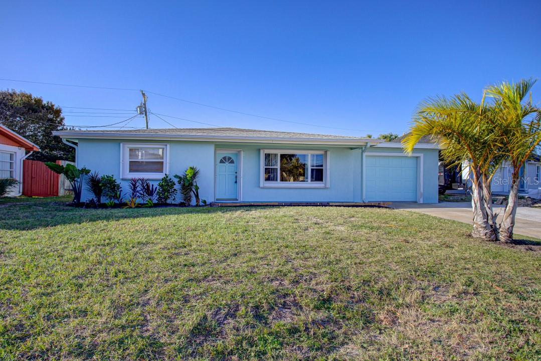 This is a Welcoming Beachside Home. The ocean is just down the street. This is a large 4 bedroom 3 bath updated home with a decorator's touch which you will see in the pictures. It is much bigger than the main photo. It has a large master bath with jetted tub and a Florida room with a log burning fireplace. The 4/3 split floor plan can also be a 3/2 and a 1/1 with a separate side entrance. The refrigerator, microwave, dishwasher, washer and dryer are new. The hurricane shutters are an added benefit. The home is in a quiet safe established neighborhood.
