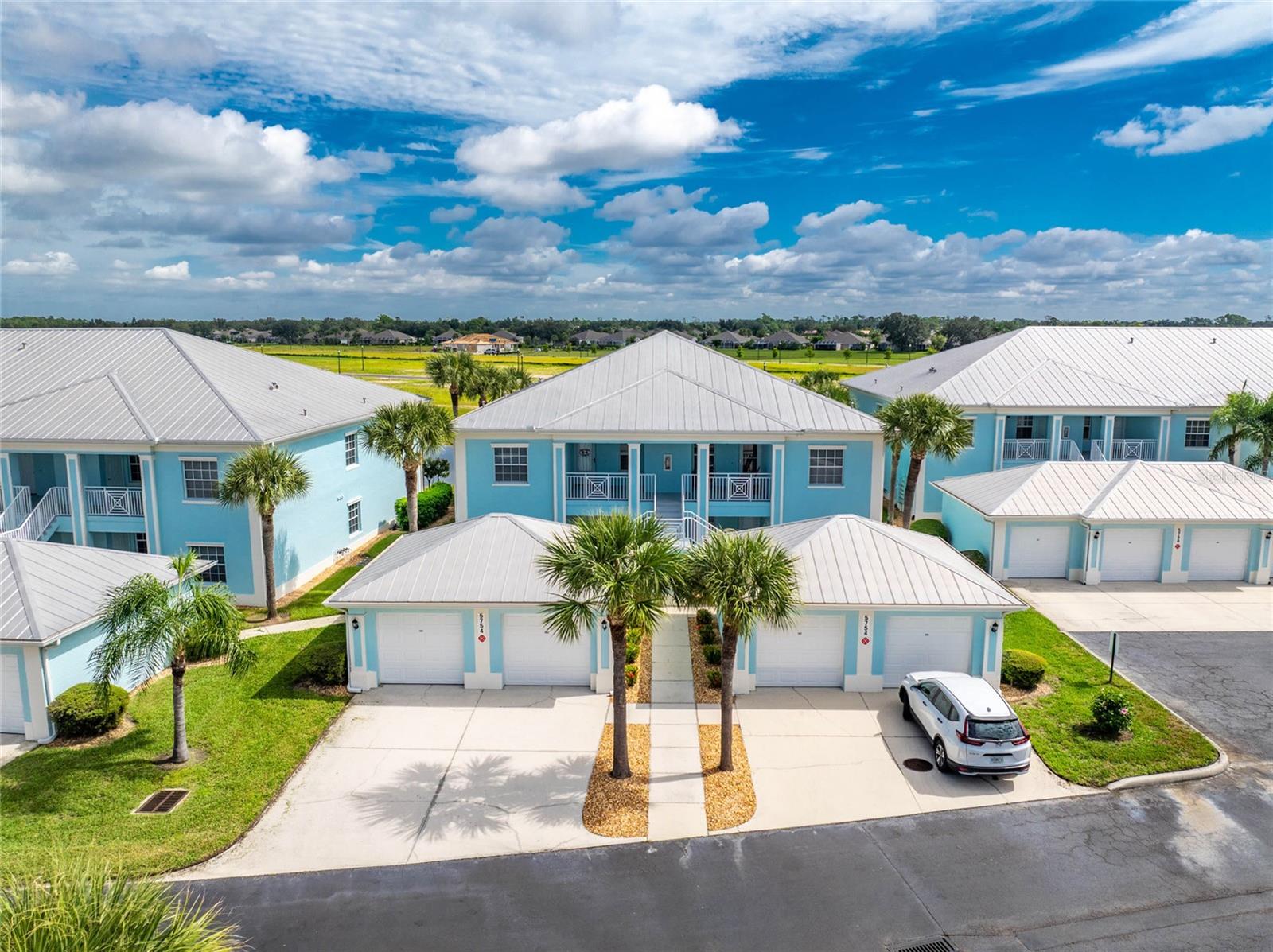 Lakefront turnkey condo in The Colony at Sabal Trace! This second-floor end unit offers 2 bedrooms, 2 full baths, a den, and comes fully furnished, making it ready for immediate enjoyment. Located in the secure, gated community of The Colony at Sabal Trace, you’ll appreciate the tropical landscaping, a private one-car garage with room to park another vehicle just outside, plus plenty of guest parking. Inside, you’ll find a bright and open layout. The kitchen is designed for both function and style with 42-inch cabinets, a large pantry, bar seating, and a dining nook. The living and dining areas flow seamlessly to the screened lanai, where wide lake views provide a peaceful backdrop. The primary suite overlooks the water and offers two closets, including a walk-in, along with an ensuite bath featuring a walk-in shower, private water closet, and pocket doors. The guest bedroom is located near the second full bath with a tub/shower. The versatile den is currently set up as a dining room but could also be used as a den, office, or extra bedroom. A laundry closet with stackable washer/dryer is conveniently located near the second bathroom. There is also an extra storage closet just outside the front door of the unit. The Colony at Sabal Trace offers resort-style amenities including a heated pool, clubhouse, billiards, ping pong, and fitness center—all with low-maintenance living and low condo fees. With comfortable finishes, tasteful furnishings, and tranquil lake views, this condo is a great opportunity to enjoy the relaxed Florida lifestyle. Schedule your showing today!