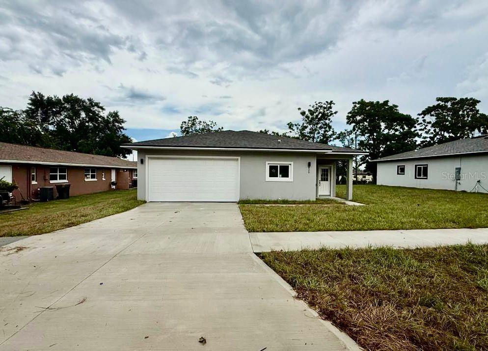 Discover this brand new single-family home in one of Clermont’s most desirable locations! Perfectly positioned just moments from Historic Downtown Clermont, the scenic Lake Minneola Waterfront Park, and local schools, this home offers the ideal blend of modern style, comfort, and convenience. Inside, you’ll find a bright and airy open floor plan designed for today’s lifestyle. The gourmet kitchen features sleek quartz countertops, upgraded shaker-style cabinets, stainless steel appliances, and a spacious center island perfect for cooking or gathering with friends and family. The primary suite includes a large walk-in shower, contemporary fixtures, and ample closet space. Both bathrooms have walk-in showers only — no bathtubs — a feature that combines style and practicality. A dedicated indoor laundry room comes with a utility sink and built-in cabinet for extra storage. The home sits on a generous lot, offering privacy and room for future outdoor upgrades like a pool or patio. A covered front entry welcomes you home, while sliding glass doors in the main living area open to the backyard, creating a perfect indoor-outdoor flow. Additional highlights include two-car garage, extended driveway, and no HOA or CDD fees. Whether you’re searching for your first home, a forever home, or an investment in a rapidly growing area, this property delivers it all. Schedule your showing today before it’s gone!
