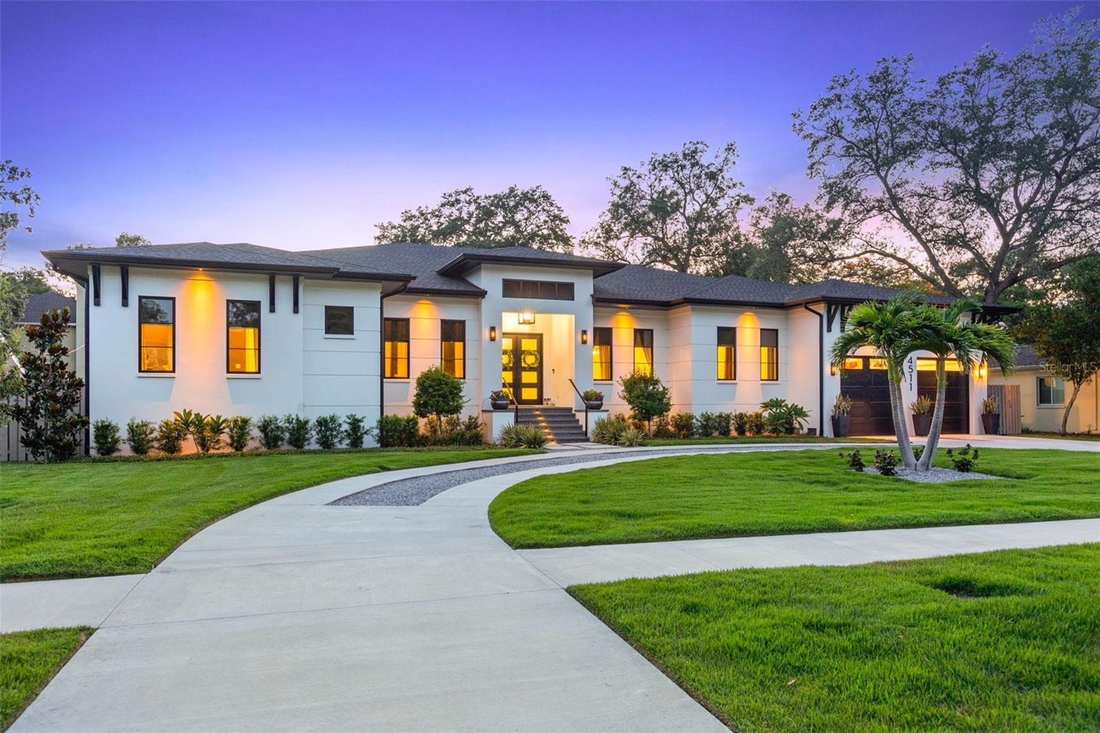 Under contract-accepting backup offers. This single-story Sunset Park residence completed in 2021 by one of Tampa's premier builders, RSB Construction is truly a rare find with 5,109 sq ft of living space sitting on just shy of a 16,000 sq ft lot. The property is set back from the road, providing privacy and a sense of exclusivity. Every aspect of this home has been meticulously designed with top-of-the-line finishes and is being sold turnkey, fully furnished. The 12-foot ceilings and engineered hardwood flooring, adorned with fixtures from renowned brands exude elegance in every room. The residence provides a well-thought-out floor plan, featuring 4 bedrooms, 4.5 bathrooms, an office, bonus room, and 3-car garage. As you enter the home through the grand 8-foot wide entryway, you'll find a tastefully designed office with a barn door entry to your left, and a dining room on your right. Continuing through the butler's pantry, which showcases cement brass tile, oak wood shelving, a sub-zero wine fridge, refrigerated drawers, and cabinetry, you'll enter the heart of the home. Here, the kitchen, living area, and outdoor space seamlessly flow together. The living room boasts beautiful custom ceiling oak beams, a gas fireplace with an oak mantle, and thin brick tile from floor to ceiling. The kitchen is a dream come true with its 11-foot 2-inch thick Quartz waterfall island with storage on both sides, a custom-paneled sub-zero fridge, a 6-burner 48" Wolf double oven gas range, a custom 54" hood, top-of-the-line plumbing fixtures, cabinetry, and appliances, reverse osmosis and an oversized walk-in pantry. Enjoy a breakfast nook with a built-in bench and separate coffee bar, complete with a water line, white oak accent wall, and cabinetry. The primary bedroom offers a luxurious retreat featuring a double door entryway, ceiling white oak beams, hanging bedside pendants, and cozy seating area. No expense was spared in the primary bathroom, with engineered hardwood flooring extending throughout. It boasts separate large vanities with oversized sinks, marble counters, pendant lighting, and mirrors. The highlight is the whole marble wall and shower, equipped with double shower heads, double benches, and large soaking tub. The primary closet is truly remarkable, featuring custom glass cabinetry, built-ins, a Quartz countertop island, chandelier, as well as a window for natural lighting. The laundry room offers custom cabinetry, oak wood countertops, drying rack, deep farmhouse sink, and elevated washer/dryer units.The three additional bedrooms in the home all feature large walk-in closets with custom shelving. The bonus room is equipped with built-in surround sound and large media closet. The outdoor space is equally as impressive, with a large lanai that includes an outdoor kitchen featuring a refrigerator, grill, hood, and sink, all topped with Quartz countertops. Enjoy the speakers, large fan, custom shiplap pine wood ceiling, and electronic screen enclosure on the lanai overlooking the sizable saltwater heated pool and spa with pavered and Trex decking. Additional features of this remarkable home include hurricane impact windows and doors throughout, speakers, irrigation system, a whole-home water softener, central vacuum, 8-foot solid wood interior doors, blackout shades in all bedrooms, and a garage with epoxy flooring, impact-rated windows, and built-in storage shelves. This is a once-in-a-lifetime opportunity to own a single story home of this caliber in the heart of South Tampa.