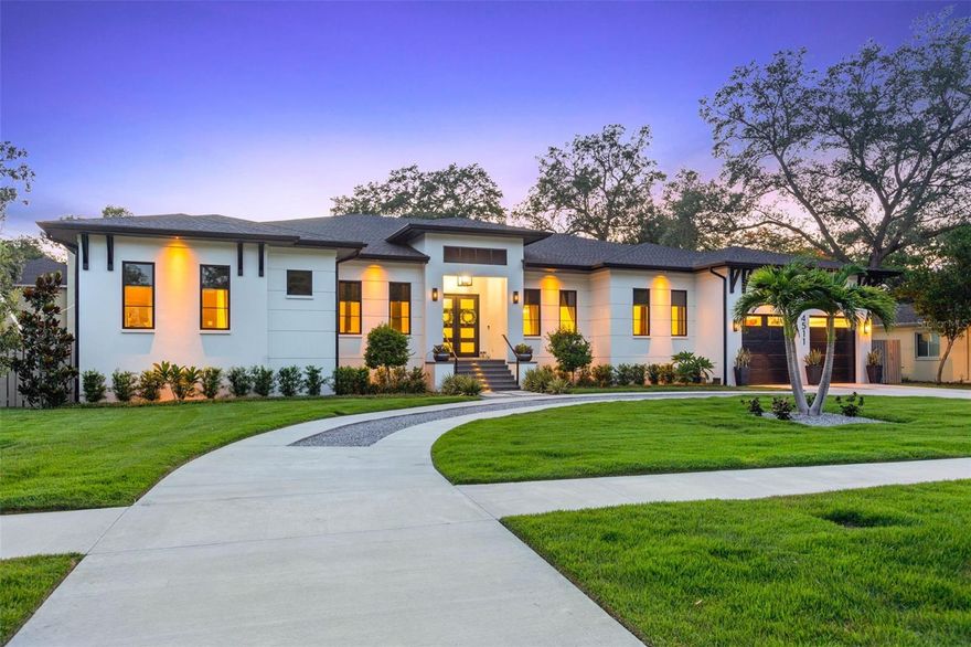 Under contract-accepting backup offers. This single-story Sunset Park residence completed in 2021 by one of Tampa's premier builders, RSB Construction is truly a rare find with 5,109 sq ft of living space sitting on just shy of a 16,000 sq ft lot. The property is set back from the road, providing privacy and a sense of exclusivity. Every aspect of this home has been meticulously designed with top-of-the-line finishes and is being sold turnkey, fully furnished. The 12-foot ceilings and engineered hardwood flooring, adorned with fixtures from renowned brands exude elegance in every room. The residence provides a well-thought-out floor plan, featuring 4 bedrooms, 4.5 bathrooms, an office, bonus room, and 3-car garage. As you enter the home through the grand 8-foot wide entryway, you'll find a tastefully designed office with a barn door entry to your left, and a dining room on your right. Continuing through the butler's pantry, which showcases cement brass tile, oak wood shelving, a sub-zero wine fridge, refrigerated drawers, and cabinetry, you'll enter the heart of the home. Here, the kitchen, living area, and outdoor space seamlessly flow together. The living room boasts beautiful custom ceiling oak beams, a gas fireplace with an oak mantle, and thin brick tile from floor to ceiling. The kitchen is a dream come true with its  11-foot 2-inch thick Quartz waterfall island with storage on both sides, a custom-paneled sub-zero fridge, a 6-burner 48" Wolf double oven gas range, a custom 54" hood, top-of-the-line plumbing fixtures, cabinetry, and appliances, reverse osmosis and an oversized walk-in pantry. Enjoy a breakfast nook with a built-in bench and separate coffee bar, complete with a water line, white oak accent wall, and cabinetry. The primary bedroom offers a luxurious retreat featuring a double door entryway, ceiling white oak beams, hanging bedside pendants, and cozy seating area. No expense was spared in the primary bathroom, with engineered hardwood flooring extending throughout. It boasts separate large vanities with oversized sinks, marble counters, pendant lighting, and mirrors. The highlight is the whole marble wall and shower, equipped with double shower heads, double benches, and large soaking tub. The primary closet is truly remarkable, featuring custom glass cabinetry, built-ins, a Quartz countertop island, chandelier, as well as a window for natural lighting. The laundry room offers custom cabinetry, oak wood countertops, drying rack, deep farmhouse sink, and elevated washer/dryer units.The three additional bedrooms in the home all feature large walk-in closets with custom shelving. The bonus room is equipped with built-in surround sound and large media closet. The outdoor space is equally as impressive, with a large lanai that includes an outdoor kitchen featuring a refrigerator, grill, hood, and sink, all topped with Quartz countertops. Enjoy the speakers, large fan, custom shiplap pine wood ceiling, and electronic screen enclosure on the lanai overlooking the sizable saltwater heated pool and spa with pavered and Trex decking. Additional features of this remarkable home include hurricane impact windows and doors throughout, speakers, irrigation system, a whole-home water softener, central vacuum, 8-foot solid wood interior doors, blackout shades in all bedrooms, and a garage with epoxy flooring, impact-rated windows, and built-in storage shelves. This is a once-in-a-lifetime opportunity to own a single story home of this caliber in the heart of South Tampa.