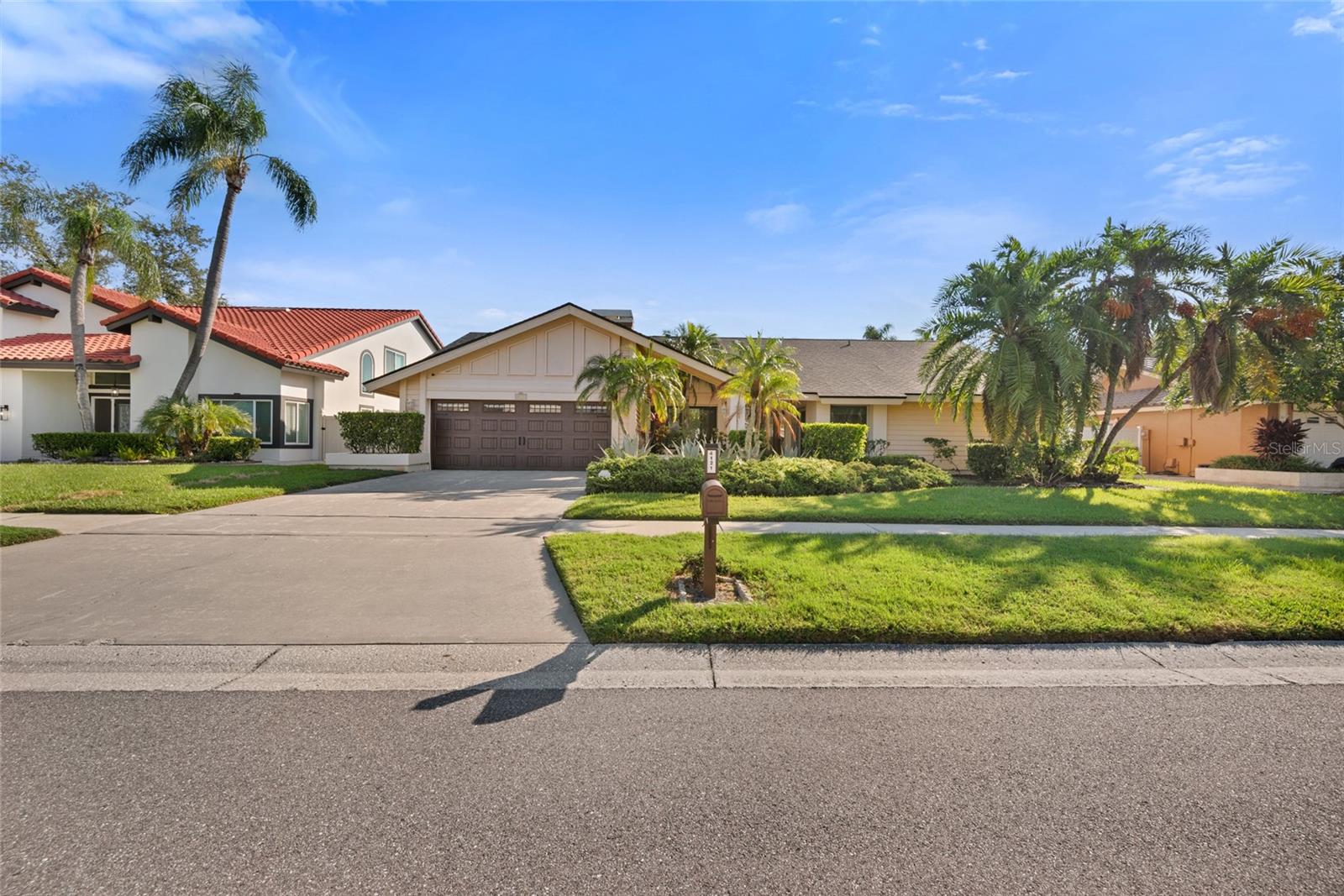 This is a bright, fresh, spacious 4 BR/2.5 BA, 2 car garage, pool home with lush mature landscaping with mango and lichee fruit trees in Sweetwater Subdivision, a desired medium sized gated community however with home lots roughly 85x134 sqft which are comparingly big in this area and nestled on the northeast end of Old Tampa Bay and just to the West of Rocky Point Golf Course and Tampa International Airport. Being on Memorial Highway, around a 20 minute drive can lead you almost every major destinations. The renowned Berkeley Preparatory School Pre-K to Grade 12 is 5 minute ride away. In year 2022 all the windows were replaced with category 5 hurricane resistant windows and sliding doors. A full new shingle roof was installed in 2024! Beautiful travertine floors in living areas and vinyl planking in all 4 bedrooms was done in December, 2020. Stainless steel kitchen appliances with refrigerator and dishwasher replaced in 2017. Additional upgrades are a solar pool heater in March 2021, a new a/c system in 2016, new roof over back lanai in 2020, a new garage door and opener in 2020 and a new pole mailbox in 2023. Fresh interior paint and a new toilet are recently done.