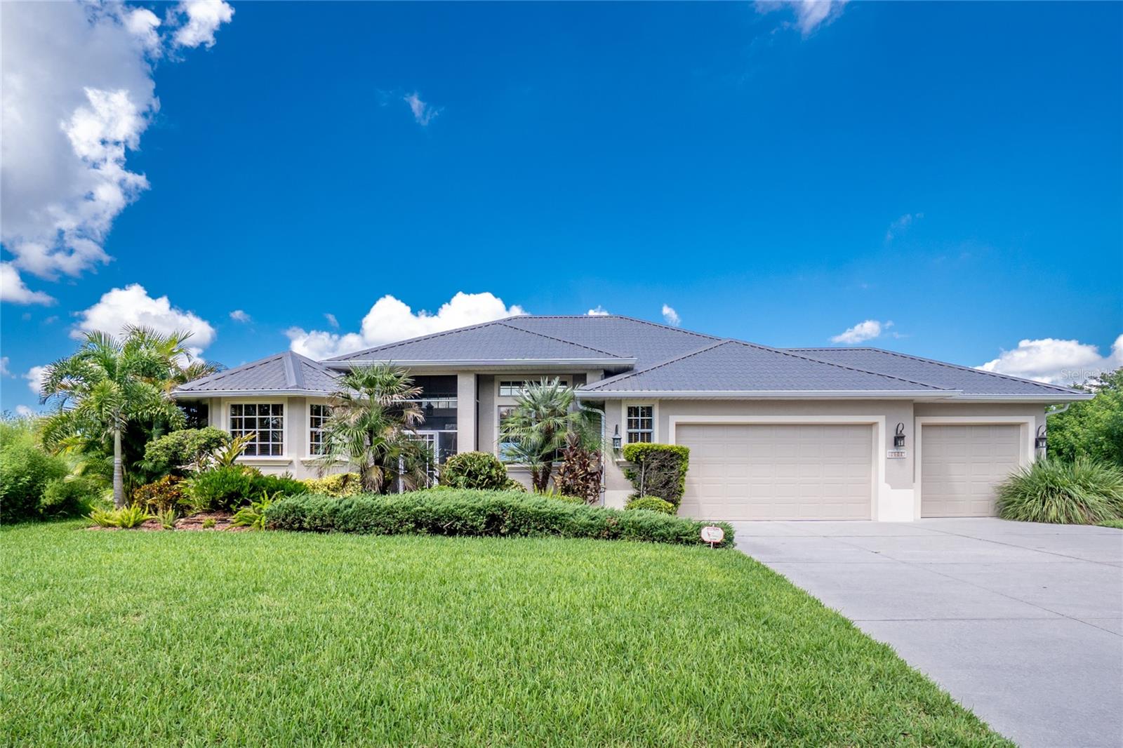 SIMPLY STUNNING with 240' of waterfront and almost .7 of an acre ! Custom built 3BD/2BA/3CG home that looks brand new! NEW PERMATILE ROOF IN 2024! Screened and tiled entry opens into the main living area featuring REAL hardwood flooring, 8' sliding glass doors to lanai, plant shelving & crown moulding. This area is very versatile - current owner is using what "could be" the living room as her formal dining room, and the dining area as her living room. Gourmet kitchen (all updated) with wood cabinetry, large island, new white Quartz countertops, new tiled backsplash + stainless updraft range hood, upgraded appliances, pantry w/pullouts, pendant lighting & newer tiled flooring! Appliances include: Kitchen Aide double door refrigerator, GE Profile microwave, GE Profile smooth top stove, & Whirlpool dishwasher. Breakfast nook offers great pool/water view & breakfast bar provides additional seating. Tiled family room has tray ceiling w/crown moulding, plant shelf, & sliding glass doors to lanai. Primary bedroom features 2 walk in California closets, hardwood floor, tray ceiling/crown moulding, & sliding glass doors to lanai also. The updated primary bath is a delight, with Roman shower w/rainhead, freestanding tub, privacy commode, double wood vanities w/granite tops, newer lighting & mirrors. Guest Bedrooms have wood flooring & wall closets plus rear bedroom also opens onto the lanai. The guest bath wasn't left out in the remodeling & features tiled shower w/seamless door, wood vanity w/granite top, medicine cabinet, mirror, lighting, single piece toilet & tiled flooring. Laundry room has built in cabinetry, utility tub & tiled flooring. 2 separate lanais for lots of entertaining, plus heated pool. 240 feet of riprap seawall, dock and boat lift make it a breeze to hop in your boat and out you go, just a short distance to the scenic Myakka River, then Charlotte Harbor and onward! Sprinkler system on well for all of the lush landscaping. Whole house RO system. All windows and doors are impact resistant so no worries about storms! AC system was replaced in 2012 and has been well maintained. This type and quality of home doesn't come along every day, so don't hesitate to make an appointment to take a look! The time to buy is NOW!