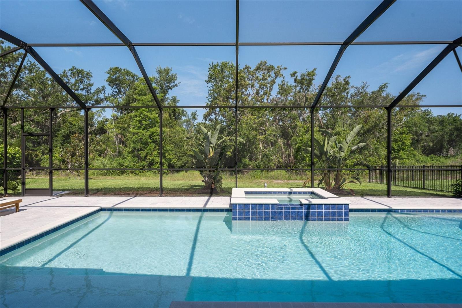 Preserve Lot with Private Pool | Luxury 5BR + Office | 3,545 Sq Ft in Premier Community. Welcome to your Florida sanctuary, where timeless design meets resort-style living. This stunning 5-bedroom plus office, 4-bathroom home offers 3,545 square feet of beautifully upgraded space, complete with a private pool and peaceful preserve views with no rear neighbors.
Set on a premium lot, this home features exceptional curb appeal with stone accents, lush landscaping, and a grand entryway. Inside, enjoy soaring ceilings, abundant natural light, and an open-concept design that seamlessly blends elegance and comfort.
The heart of the home is the gourmet kitchen, featuring quartz countertops, a large island with bar and table seating, custom cabinetry, a walk-in pantry, and stainless steel appliances, perfect for entertaining or everyday living.
A dedicated home office with French doors offers privacy and flexibility. The spacious owner’s suite includes a spa-inspired bathroom with a soaking tub, dual vanities, a glass-enclosed shower, and walk-in closets. Upstairs, a large bonus loft provides flexible space for a media room, game room, or second living area.
Step outside to your backyard retreat with a resort-style pool, covered lanai, and tranquil preserve backdrop, offering year-round enjoyment and rare privacy.
Located in one of Parrish’s most amenity-rich communities, enjoy access to a fitness center, pickleball courts, soccer fields, playgrounds, fire pits, game lounges, a co-working café, and scenic walking and biking trails.
Just minutes from I-75, top-rated schools, shopping, dining, and Florida’s award-winning Gulf Coast beaches, this home offers the best of location, lifestyle, and luxury. Schedule your private showing today.