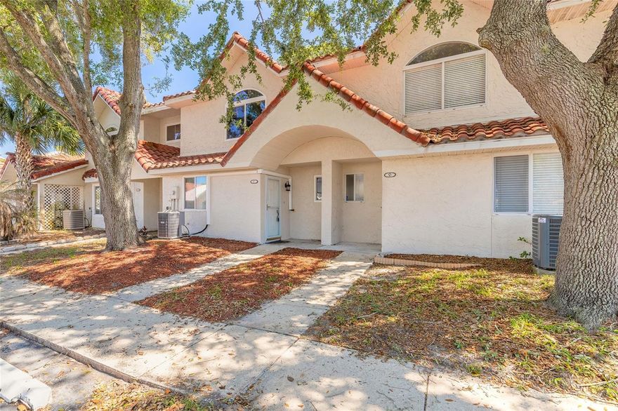 Spacious townhome located in the Townhomes West at Port Orange community. This property offers a great opportunity for a primary residence, seasonal getaway, or investment property with room to update and personalize. Features include a large living and dining area, functional kitchen with breakfast bar, and an enclosed rear patio offering additional living or entertaining space. Enjoy a private backyard area with screened enclosure seating, perfect for relaxing outdoors. Both bedrooms feature walk-in closets and private bathroom access, with additional storage throughout the home. Convenient first-floor half bath and indoor laundry area add to the functional layout. 2022 AC system and 2014 water heater. HOA amenities include lawn care, grounds maintenance, private road maintenance, and community pool access. Conveniently located near Embry-Riddle, Daytona State College, Halifax Hospital, shopping, dining, major highways, and area beaches.