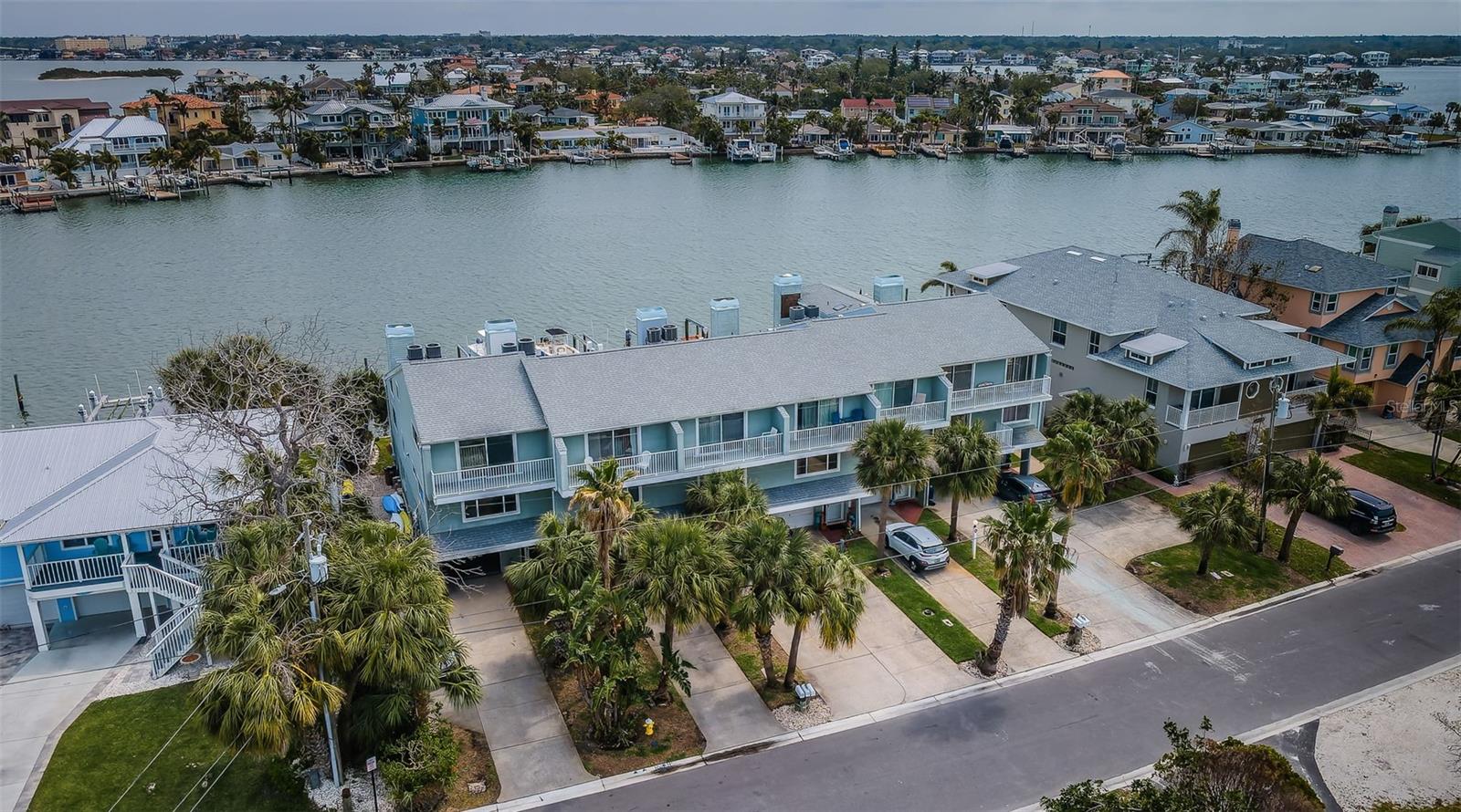 Indulge in the ultimate Indian Rocks Beach and Florida lifestyle with this exquisitely updated 3-bedroom 3-bath waterfront retreat with a boat lift. Only about 400 steps to the white sandy beach, this meticulously designed and sophisticated unit boasts elegant wood floors, crown molding, custom electric shades, and custom blinds, creating an atmosphere of refined comfort. Downstairs, you will find a large ensuite with sliding doors and direct access to the pool. On the second floor, you will enjoy a second large bedroom, bath, kitchen, and large living area with sliders leading to a balcony with amazing views. Upstairs is reserved for the spacious primary bedroom, which features a balcony, skylights, and a sizable spa-like bath with custom closets. The residence also features hand-crafted stair rails, ceiling fans inside and out, large custom closets throughout, and glistening skylights for a light and bright feel. For chilly nights, enjoy a fire in the wood-burning fireplace. Step directly out to the sparkling pool and beyond to the breathtaking Intracoastal Waterway, where a 10,000 lb. boat lift awaits, perfect for boating enthusiasts enjoying a quick 10 minutes to the Gulf.
Enjoy the convenience of a golf cart-friendly neighborhood, with an array of wonderful restaurants just moments away. For recreation and relaxation, a community park featuring tennis courts and a playground is conveniently located just one block away.
This turnkey property offers seamless indoor-outdoor living, combining luxurious updates with the vibrant community atmosphere of Indian Rocks Beach. A large garage can hold all your beach toys, golf cart and your car. This is a rare opportunity to own a slice of paradise where waterfront adventures and community connections come together."
Tampa Airport is just 35 minutes as is downtown St Pete.