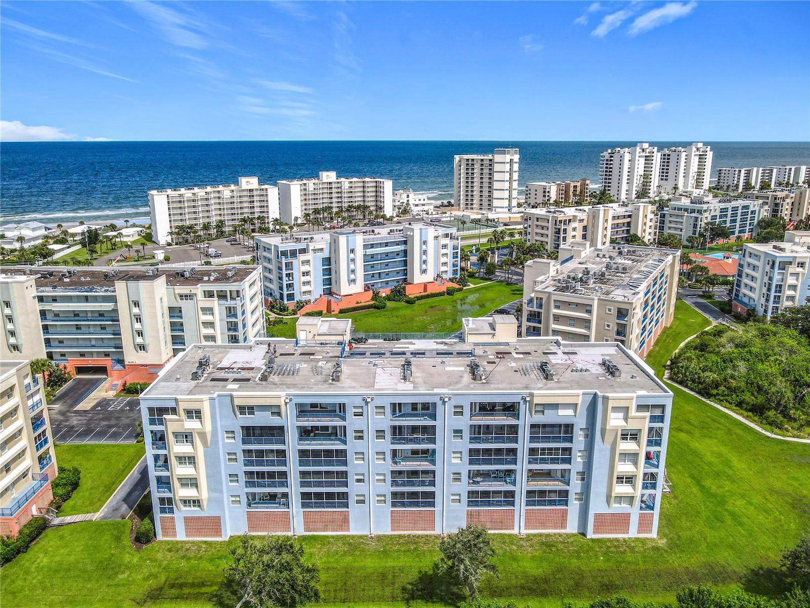 Step into luxurious coastal living with this stunning 3-bedroom, 2-bath 5th-floor beach condo. Enjoy sweeping 180-degree of private unobstructed estuary views with stunning sunsets, plus ocean-peak views from the front of this unit. The Ocean Tide floor plan provides a spacious layout with over 1,700 square feet of comfortable living space. Property comes with a brand new Coastal furniture-package, brand new onyx stainless steel LG washer and dryer, high end onyx stainless steel kitchen appliances, upgraded ceiling fans and light fixtures, 9-foot ceilings, custom built closet organizers in each bedroom, large laundry room with utility tub, and upgraded Zebra window shades. The screened-in balcony has been tiled and comes with Coolaroo sunshades. New HVAC from 2024. All assessments paid. Elevator in building. This beautifully appointed retreat is turn key, move in ready so you can start enjoying the beach lifestyle. This unit has never been rented. Ocean Walk amenities include two heated pools, two fitness facilities, hot tubs, lighted tennis courts, barbecue area, shuffleboard, bocce ball and a nature walking trail. The community also provides garage parking, two secured gated entrances, and easy access to private walkover to the no-drive beach.