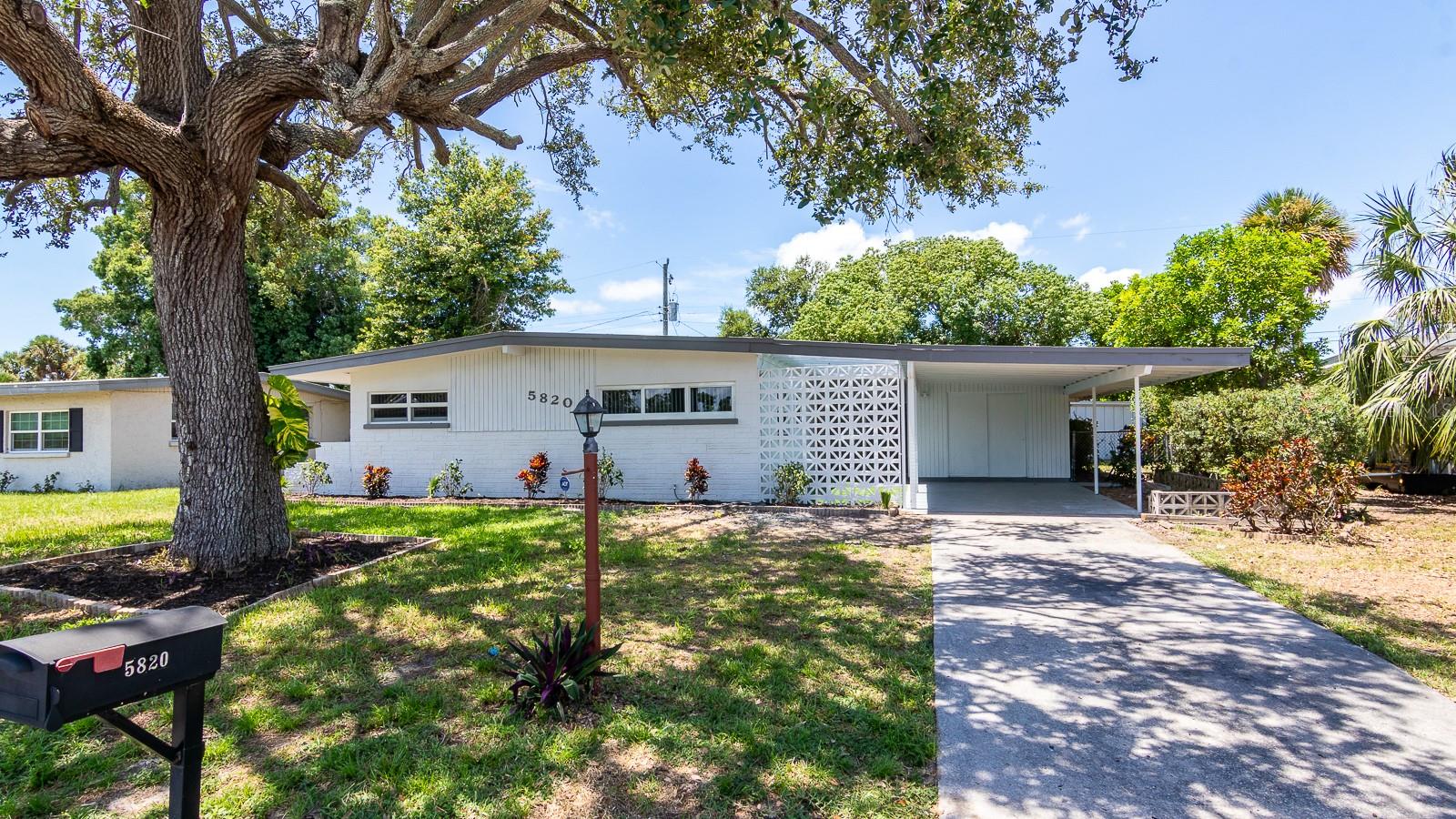 Welcome to this beautifully updated, vacant, and staged single family home in South Bradenton. In 2025 a NEW Roof & NEW Impact Windows were installed. The interior has vinyl plank flooring in the main living areas with ceramic tile in the bathrooms. The open floor plan has a beautiful kitchen with quartz counters, new appliances, large range hood, skylight, shaker cabinets, and undermount sink with disposal. The large living room has plenty of natural light and tall ceilings. There is a dedicated primary suite with full size bathroom with standing shower with new tile surround. The guest bath has a bathtub with new tile surround. Both bedrooms have ceiling fans and custom storage with pullout drawers alongside the main closets. Outside the sliding glass doors is a spacious Florida room with an additional Utility area for Washer/Dryer hookups. The backyard is fenced and has a small metal storage building. The front carport provides car coverage with a small area for lawn chairs on some newly placed turf. 2021 Air Conditioner. NON-Flood Zone. There is natural gas (TECO) to the house that currently feeds the Hot Water Heater. 150amp electric service. Property is vacant and easy to see. Southwood Village is located just north of Bayshore Gardens and close to shopping, restaurants, Sarasota Airport and more! Please call your real estate agent or Dane to see today!