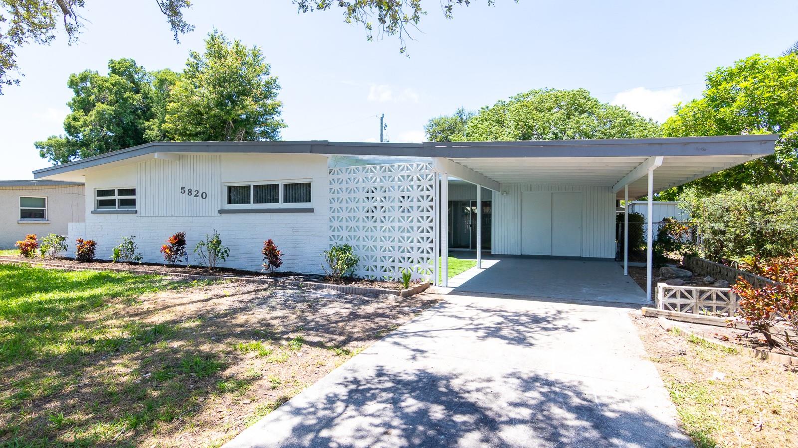 Welcome to this beautifully updated, vacant, and staged single family home in South Bradenton. In 2025 a NEW Roof & NEW Impact Windows were installed. The interior has vinyl plank flooring in the main living areas with ceramic tile in the bathrooms. The open floor plan has a beautiful kitchen with quartz counters, new appliances, large range hood, skylight, shaker cabinets, and undermount sink with disposal. The large living room has plenty of natural light and tall ceilings. There is a dedicated primary suite with full size bathroom with standing shower with new tile surround. The guest bath has a bathtub with new tile surround. Both bedrooms have ceiling fans and custom storage with pullout drawers alongside the main closets. Outside the sliding glass doors is a spacious Florida room with an additional Utility area for Washer/Dryer hookups. The backyard is fenced and has a small metal storage building. The front carport provides car coverage with a small area for lawn chairs on some newly placed turf. 2021 Air Conditioner. NON-Flood Zone. There is natural gas (TECO) to the house that currently feeds the Hot Water Heater. 150amp electric service. Property is vacant and easy to see. Southwood Village is located just north of Bayshore Gardens and close to shopping, restaurants, Sarasota Airport and more! Please call your real estate agent or Dane to see today!