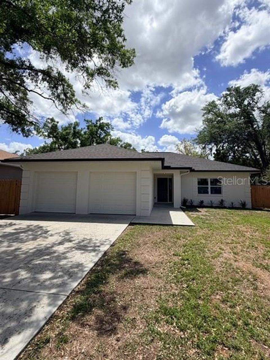 Beautifully rebuilt home with 3 bedrooms and 2 baths.  Modern kitchen with solid surface countertops, range, refrigerator, microwave and dishwasher. There is laminate flooring thru out.  The dining room features contemporary light fixture and is open to the upgraded kitchen.  You'll love the modern bathrooms with decorator fixtures, cabinets and fixtures. Concrete driveway leads to 2 car garage with opener. This home has been completely renovated.  This one will not last long.