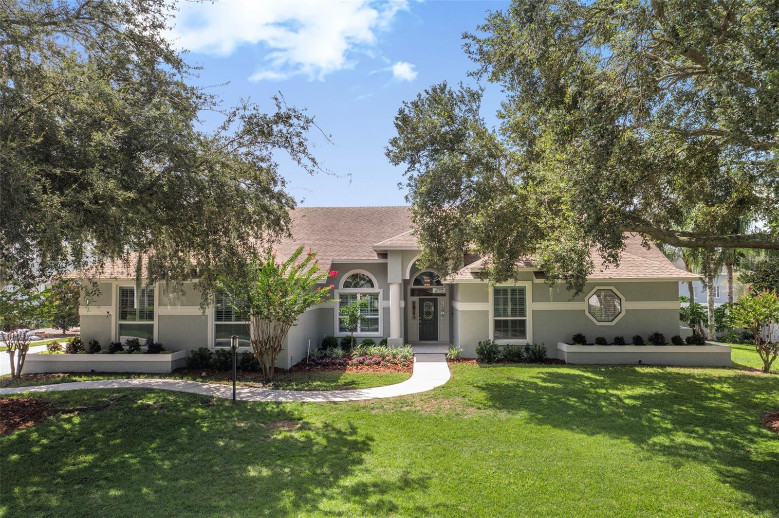 One or more photo(s) has been virtually staged. Welcome to this stunning one-owner executive residence, custom-built by Jeff Thurn and located in the highly sought-after gated South Lakeland community of Hamilton Place. This exceptional home offers 4 true bedrooms plus a office/den, thoughtfully designed with timeless craftsmanship and extensive upgrades. Step through the elegant foyer and be greeted by gleaming wood floors, soaring volume ceilings, rich crown molding, custom baseboards, and plantation shutters throughout. The formal living and dining rooms flow seamlessly, with French doors opening to the oversized screened lanai, perfect for entertaining. The resurfaced 2024 swimming pool is the centerpiece of the outdoor living space. The primary suite is a private retreat, featuring luxury vinyl plank flooring, two custom walk-in closets with built-ins, and a beautifully updated bath with dual sinks, a soaking tub, a walk-in shower and a make-up/vanity area. The heart of the home is the expansive chef’s kitchen, complete with custom wood cabinetry and roll-out shelving, a solid Brazilian cherry center island with prep sink, a breakfast bar, desk area, wet bar, and a sunny breakfast nook overlooking the pool. Additional highlights include: Powder room off foyer. Guest bedroom with private en suite bath – perfect for an in-law suite or teen retreat. Two more spacious bedrooms both with walk-in closets, and an updated hall bath with pool access. Office/Den with custom built-ins and decorator ceiling fan - perfect for working from home! Inside laundry room with utility sink and abundant storage. Oversized two-car garage with additional storage. Extensive updates ensure peace of mind:
New roof (2020), all 22 windows replaced with South Tampa hurricane-rated windows, new 3.5-ton AC (2023), exterior repainted (2023),
luxury vinyl plank flooring or neutral tile throughout – no carpet!, whole-home water softener system (2023), updated bathrooms, new comfort-height toilets, new ceiling fans, LED exterior lighting. A leased 100-gallon propane tank fueling fireplace is located on the west side of the home. This exceptionally well maintained, move-in ready home has been lovingly cared for and is now offered for the first time. Don’t miss the chance to make it yours—schedule your private showing today!