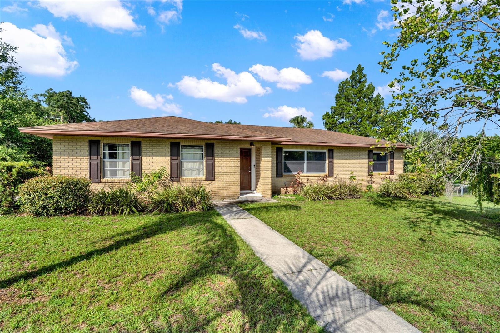 Located in "Northern Oaks" this 3-bed 2-bath home is ready for new owners. This home boasts just over 1,500 heated sqft of living space. The layout is comprised of multiple living spaces (living room & family room) and a split floorplan. If you are looking for a clean move-in ready home, this may be the one for you. The home was recently refurbished with fresh paint throughout the interior, new vinyl flooring, some updating to the bathrooms, and some updating to the kitchen as well. In addition, this home also features a 2-car garage, a screened in back patio, and fenced in back yard. The home itself is block home with a brick design and is situated on a concrete slab. The Northen Oaks neighborhood is a non-HOA cul-de-sac neighborhood with no through streets. The community also features sidewalks throughout the neighborhood. The home itself is on a corner lot and has some great curb appeal with a variety of different landscaping/trees (bottlebrush, palms, hedges, etc.). This location puts you approximately 5 mins from the heart of Downtown Deland and convenient access to groceries, shopping, restaurants, and everything else Deland has to offer. Call today to schedule a private showing!