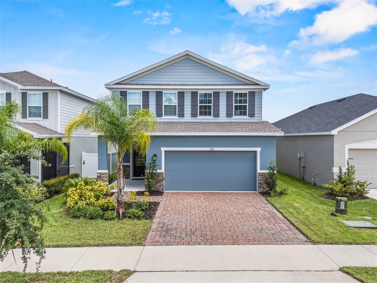 This two-story, 4-bedroom, 2.5-bath home was built in 2023 and offers 2,370 square feet in Davenport's newer community of Astonia. The open-concept main floor flows easily from the kitchen to the living and dining areas, with a custom built-in TV wall that adds both function and style.
On the first floor, you'll also find a flex room with French doors, ideal as a home office, study, or even a potential fifth bedroom.
Upstairs, you’ll find all four bedrooms plus a spacious loft, perfect for a home office, playroom, or movie space. The owners are also leaving behind their Tonal exercise machine.
You’ve got a covered front porch for relaxing, plus a back patio for outdoor meals or weekend hangouts. And when you’re ready for a little more action, the community pool and playground are just a short walk away.
Need to run errands or catch a movie? Posner Park Village is right up the road with Target, HomeGoods, Marshalls, Hobby Lobby, restaurants, and a theater all in one spot.