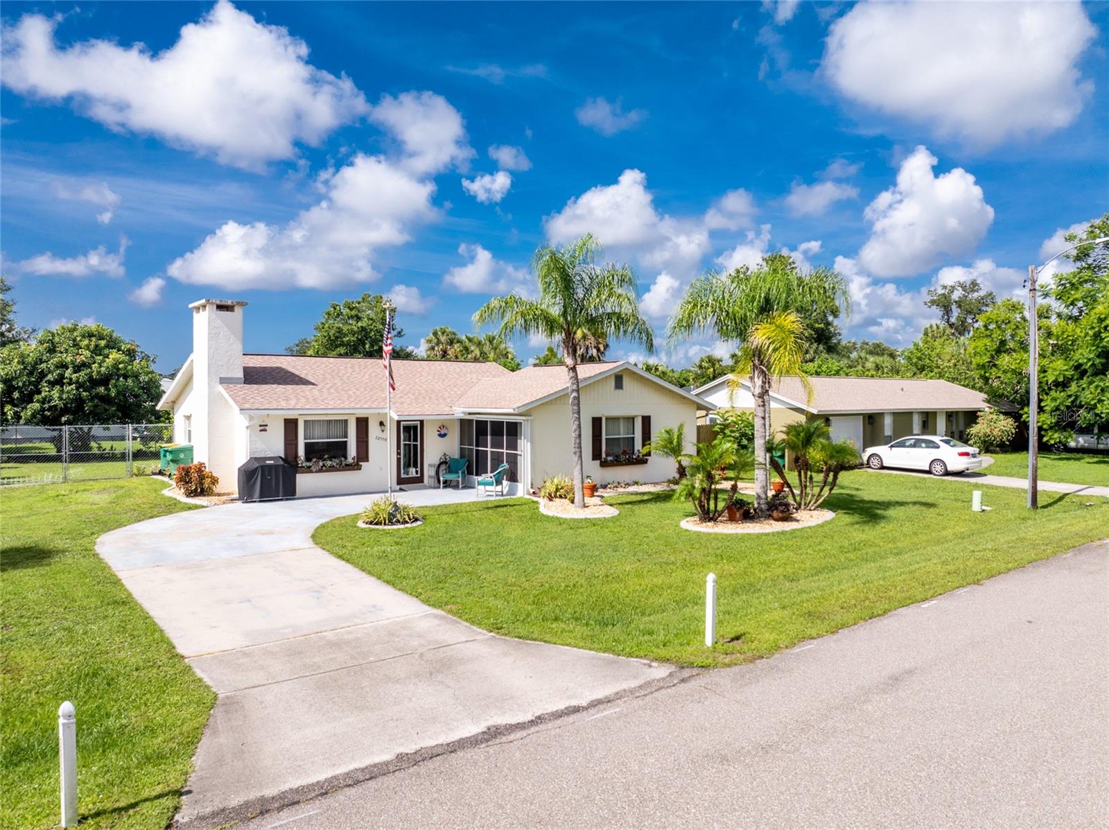 This charming home looks like it belongs on a Hallmark card—warm, welcoming, and surrounded by beautifully manicured landscaping that adds curb appeal from every angle. Inside, you'll find a thoughtfully updated interior with tile flooring throughout the entire home, creating a clean, cohesive look that's both stylish and easy to maintain. The spacious eat-in kitchen features oak cabinetry, accent lighting, ceramic tile flooring, a pantry, and all appliances included. The cozy living room centers around an electric gas fireplace, perfect for quiet evenings at home. The primary bathroom is a luxurious wet room with a modern walk-in shower, offering comfort and accessibility. This home has been meticulously cared for, with major updates including a new roof (2022), new tankless water heater, and newer chain-link fence enclosing the fully fenced yard. The AC system (2010) is in excellent condition, and washer and dryer are included. It’s also handicap accessible from both the front and back entrances, adding extra functionality and peace of mind. Additional features include hurricane shutters and a storage shed. Located just minutes from Port Charlotte Beach Park—complete with boardwalk, outdoor pool, fishing pier, and more—and close to top-rated golf courses, Fisherman’s Village in Punta Gorda, charming downtown areas, and major airports. This home truly blends comfort, convenience, and character in one exceptional package.