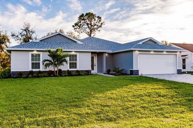 Under Construction. PHOTOS ARE MODEL MATCH - HOME UNDER CONSTRUCTION WILL BE IDENTICAL/NEAR IDENTICAL MATERIALS AND FINISHES. Other lots available for immediate construction (see attachment). Located in the desirable Palm Harbor Neighborhood of Palm Coast, with great proximity to navigable water. This stunning Verona 3 model, brand-new majestic floor plan will soon be complete and ready for occupancy before Oct! Offering 4 bedrooms 2 full bathrooms, and a 2-car garage, this home features 2009 Heated square feet of thoughtfully designed living space. The open-concept layout is perfect for relaxing or entertaining, and a stylish island kitchen with a view of it all. The split-bedroom floor plan places three bedrooms on one side and the private owner’s suite on the other. The master bedroom features dual closets and an en-suite bathroom with raised-height wood vanities and upgraded fixtures. The heart of the Verona 3 model lies in its open-concept kitchen and great room, with direct access to a covered back lanai for indoor-outdoor gatherings. The gourmet kitchen includes wood cabinets, Energy Star-rated appliances, and a large pantry. A semi-private dining room adds an intimate touch. Functionality is paramount with a utility room doubling as a laundry space, while the two-car garage with epoxy coated floor offers additional storage. Experience modern living with the Verona 3, where luxury meets efficiency in every detail. Includes a 1-year builder warranty. Builder has a strong track record of quality builds, on-time or early delivery, along with excellent finishes and attention to detail. Top rated nearby schools, great nearby shopping and access to the Intracoastal.