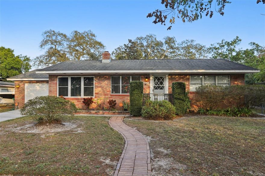 Set on a large, fenced double lot in the heart of Forest Hills, this 2-bedroom, 1-bath 1956 mid-century home offers timeless character, abundant natural light, and great outdoor living. Surrounded by mature oak trees on a quiet, established street, the setting feels peaceful yet remains close to everything Tampa has to offer. Inside, original hardwood floors, crown molding, and custom-painted cabinetry by the original owner create warmth and authenticity rarely found today. The open floor plan flows easily and is filled with light from its east-west exposure. A wood-burning fireplace anchors the main living area, adding charm and comfort. The single-car garage and oversized backyard are highlights, with privacy landscaping, a newer paver patio, and a tranquil fountain garden, perfect for entertaining, relaxing, or future expansion. Recent improvements include NEW exterior patio doors in 2024 and a professionally restored chimney after storm-related repairs in 2024. The HVAC system has been maintained twice yearly by Nuccio Air.
This home offers a buyer the opportunity to personalize while preserving its original mid-century appeal. With solid bones, a generous lot, and a sought-after Forest Hills location, 9403 N Edison Ave is a rare find with great potential.