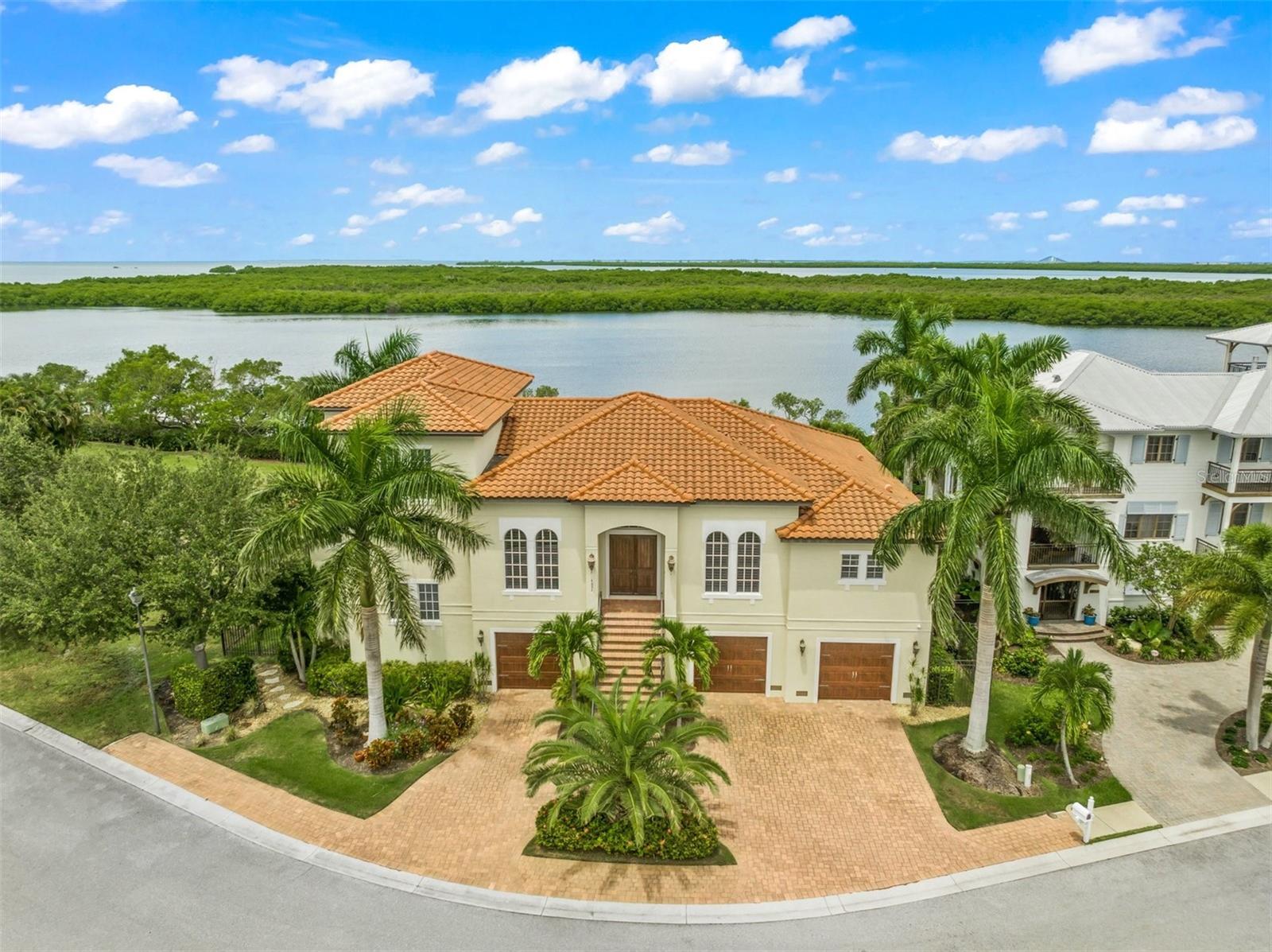 Views… views…views. Panoramic waterfront front views from most rooms of this luxurious home fronting Champlain Bayou on Snead Island, a boater’s paradise and home to the Bradenton Yacht Club. Redfish Court is situated in the exclusive Mangrove Point community, a private and small enclave of over twenty newer homes. This beautifully appointed custom John Cannon home offers spectacular views, spacious and bright living spaces, a chef’s kitchen and wonderful outdoor living space. Entry to the home is via the grand staircase in front or through the six plus car garage where an elevator services the two living levels. The first floor living area offers a smartly designed split plan with an oversized master suite including a spa bath and two large walk-in closets. On the opposite side of the home are two guest rooms with en-suite baths plus an office, formal dining room, great room and well-appointed chef’s kitchen. The laundry room and walk-in pantry are adjacent to the kitchen. Upstairs features a second office with water views, media room or possibly 4th bedroom plus a gym/work-out room opening to a patio overlooking Champlain Bayou. Across the back of the house, sliders lead to the pool, and outdoor living area plus outdoor kitchen. The ground level garage, in addition to ample parking for six plus cars, offers loads of storage and a big workshop area. Exclusive Snead Island has long been a boaters dream and is home to Emerson Point Preserve, an amazing 365 acre preserve that runs along the west side of the island. Call today to see beautiful Snead Island and this special home.
