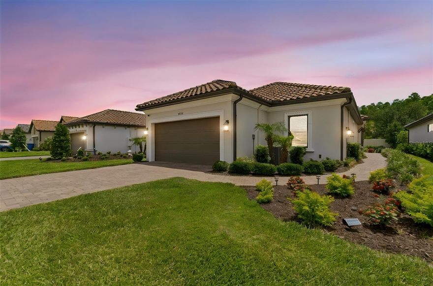 Experience the epitome of the Florida lifestyle in the highly sought after Esplanade of Wiregrass Ranch in this better than a model 1,934 SF Arezzo floorplan with 3 bedrooms, 2 full baths, 2 car extended garage with den/office and no rear neighbors. This home is a thoughtfully designed single story layout that features a spacious open floor plan that makes everyday living convenient and creates a welcoming space for entertaining or relaxing with friends. The kitchen is the heart of the home that features quartz countertops on a stone island front, stainless steel appliances, glass cabinet door fronts, subway tile backsplash, and custom pendant lights. 
Primary suite features, crown molding, dual sinks, frameless shower, and a large, divided closet. Bedroom 2 has a pocket door to create a second ensuite and a custom wood feature wall. Bedroom 3 is large and has ample light. Step outside to a covered and expanded screened lanai with upgraded pavers, perfect for your sunrise morning coffee, shaded dinners or cool evening get-togethers. 
Upgrades include but are not limited to custom crown molding in every room, an den/office with French doors and wood accent wall, laundry room with lots of custom upper/lower cabinets , counter tops and a sink. You will also find 8-foot doors, plantation shutters, crown molding and custom paint throughout, a designer glass front door, sprinkler system with reclaimed water, gutters, dining room with a full mirror wall, designer light fixtures, framed bathroom mirrors, and extensive woodwork add a welcoming feel.
Esplanade is a vibrant gated community with amenities such as a resort style pool, hot tub, cabanas, and a dog park.  The Venue has a state-of-the-art fitness center, billiard/card room, and spa room, as well as a large meeting/ gathering area with a full-time onsite lifestyle manager. For active outdoor entertainment there is a firepit, tennis courts, 8 pickleball courts, bocci, and walking trails. You will have plenty of ways to stay active, relax and connect with neighbors. Esplanade also includes worry free yard maintenance, reclaimed water and Spectrum TV and internet package included in fees.   This home is located only minutes from shopping, I-275, I-75, hospitals, restaurants, recreation, and entertainment.  Come see for yourself this exquisite residence that is ready for you to move in and be excited to call it home! Schedule your showing today and come experience the lifestyle this home and community has to offer.  Please see walkthrough and 3D tours.
