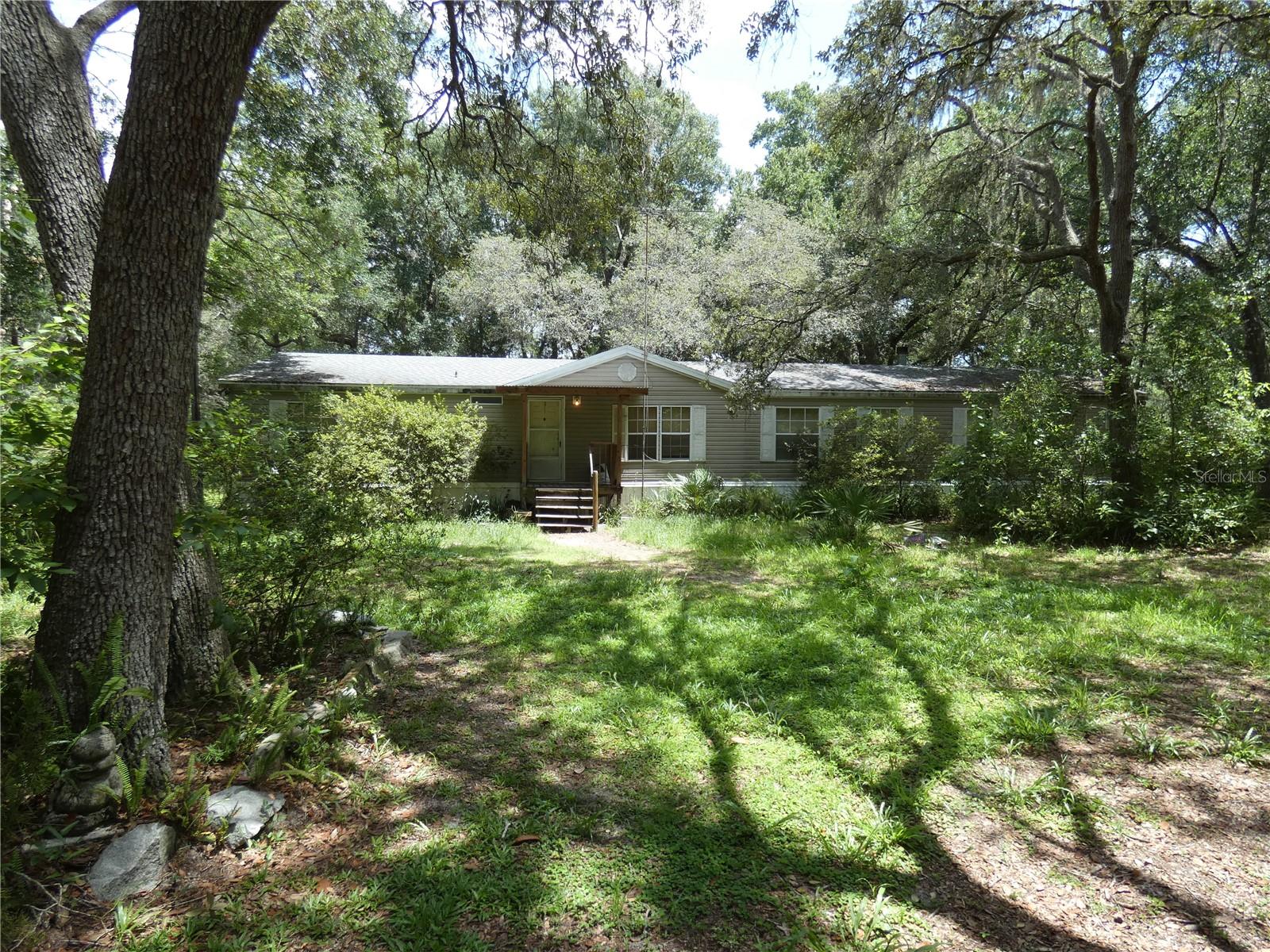 Welcome to living in the Country. Newer roof and newer AC! This large 4 bedroom home, with 2.5 bath is a little over 2000 heated square feet with vaulted ceilings, split plan, eat in kitchen, family room and inside laundry room has plenty of room for your family.Primary bedroom has expanded area for den or nursery. This home sits on 1 acre land and has plenty of room to park your RV, Boat, four wheelers, and so much more. Zoned AC. Don't let this one get away from you. Hurry must see.