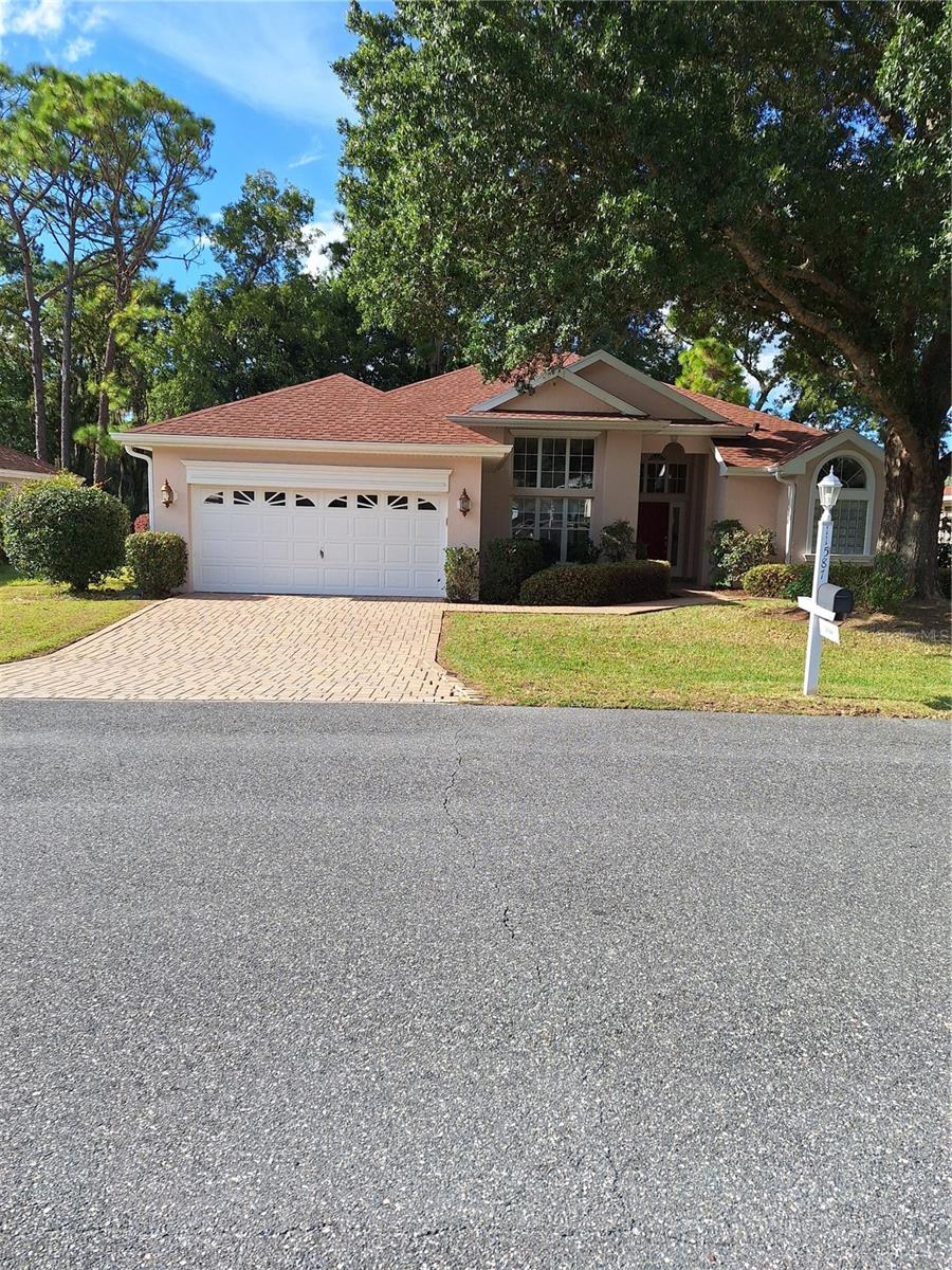 Welcome to this beautiful 3 bedroom, 2 bathroom GOLF COURSE VIEW Home offering 2,277 sq ft of comfortable living space. MORE PICTURES TO FOLLOW. Built with durable block and stucco construction, this home blends timeless style with lasting quality. A custom paver driveway and walkway adds to the home's curb appeal, offering both beauty and durability as you arrive. Inside, an open and airy floor plan features generous living and dining spaces, perfect for both everyday living and entertaining. The well-appointed kitchen is designed for functionality and flow, making meal prep a breeze. The primary suite offers a peaceful retreat with views of the lush golf course with two walk-in closets and a private en-suite bathroom with dual sinks, walk-in shower, garden tub with decorative glass-block window above and linen closet. Two additional bedrooms and a second full bath located on the opposite side of the home provide flexibility for guests, home office, or hobbies. Another great feature of this home is the inside laundry room which includes a sink and plenty of cabinets for storage needs. Enjoy golf course views right from your enclosed lanai - ideal for morning coffee or sunset relaxation!! ROOF 2023, A/C 2021, Exterior of home painted in 2023. Located in the highly desirable Oak Run Golf Club community which offers 6 pools, 5 hot tubs, fitness centers, restaurant, championship golf course (extra fees), and over 110 clubs to join. Don't miss this rare opportunity..schedule your showing today!!