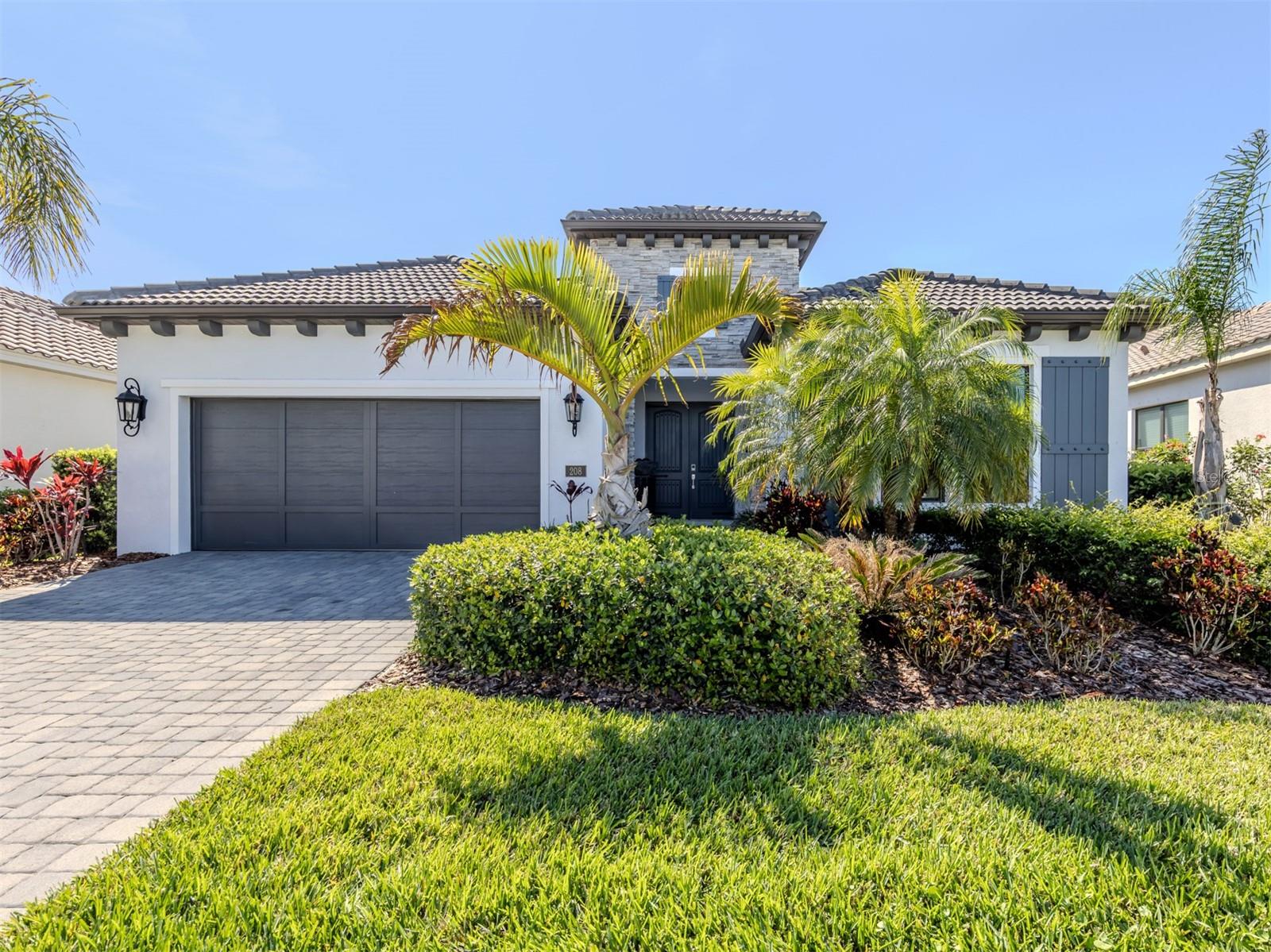 One or more photo(s) has been virtually staged. PRICE IMPROVEMENT—This luxury Neal Signature home is the BEST VALUE in Aria, offering exceptional living in North Venice’s sought-after gated enclave. Located in a boutique, maintenance-assisted community of fewer than 200 homesites, this spacious semi-custom Veneto model offers 2,635 sq ft of thoughtfully designed living space with 3 bedrooms, 3 full baths, soaring ceilings (10–13 ft), and 8-ft interior doors.
INTERIOR UPGRADES include 6x36 wood-look tile, crown molding, and quartz countertops throughout. The formal dining room can serve as a gathering space or convert to a study with French doors. A private guest suite with en suite bath is perfect for visitors or multi-gen living. The oversized laundry room offers built-in cabinetry, solid-surface counters, utility sink, and ample storage.
CHEF’S KITCHEN features quartz counters, GE Profile appliances, 5-burner gas cooktop, double wall oven with convection/microwave, farmhouse sink, coffee/wine bar, butler’s pantry, and a walk-in pantry with wood shelving. Herringbone subway tile backsplash adds elegance.
OWNER’S SUITE includes a coffered ceiling, dual walk-in closets, built-in linen tower, double vanities, oversized walk-in shower, and private water closet.
OUTDOOR LIVING boasts a custom heated pool and spa with remote controls, extended lanai, and stub-out for future outdoor kitchen with sink. Storm shutters and a community privacy wall provide added protection.
ENERGY & TECH SMART Home security system, JuiceBox EV charger, and natural gas appliances offer modern comfort and efficiency.
COMMUNITY AMENITIES include a clubhouse, heated pool/spa, fire pit, eight pickleball courts, 24/7 fitness center, and lifestyle coordinator—with NO CDD fees.
PRIME LOCATION 5 minutes to I-75, 10 minutes to Venice Beach, Nokomis Beach, and downtown Venice, and just 15 minutes to Sarasota. Aria blends luxury, convenience, and a vibrant Florida lifestyle. Contact us today for details or to explore this exceptional home in person.