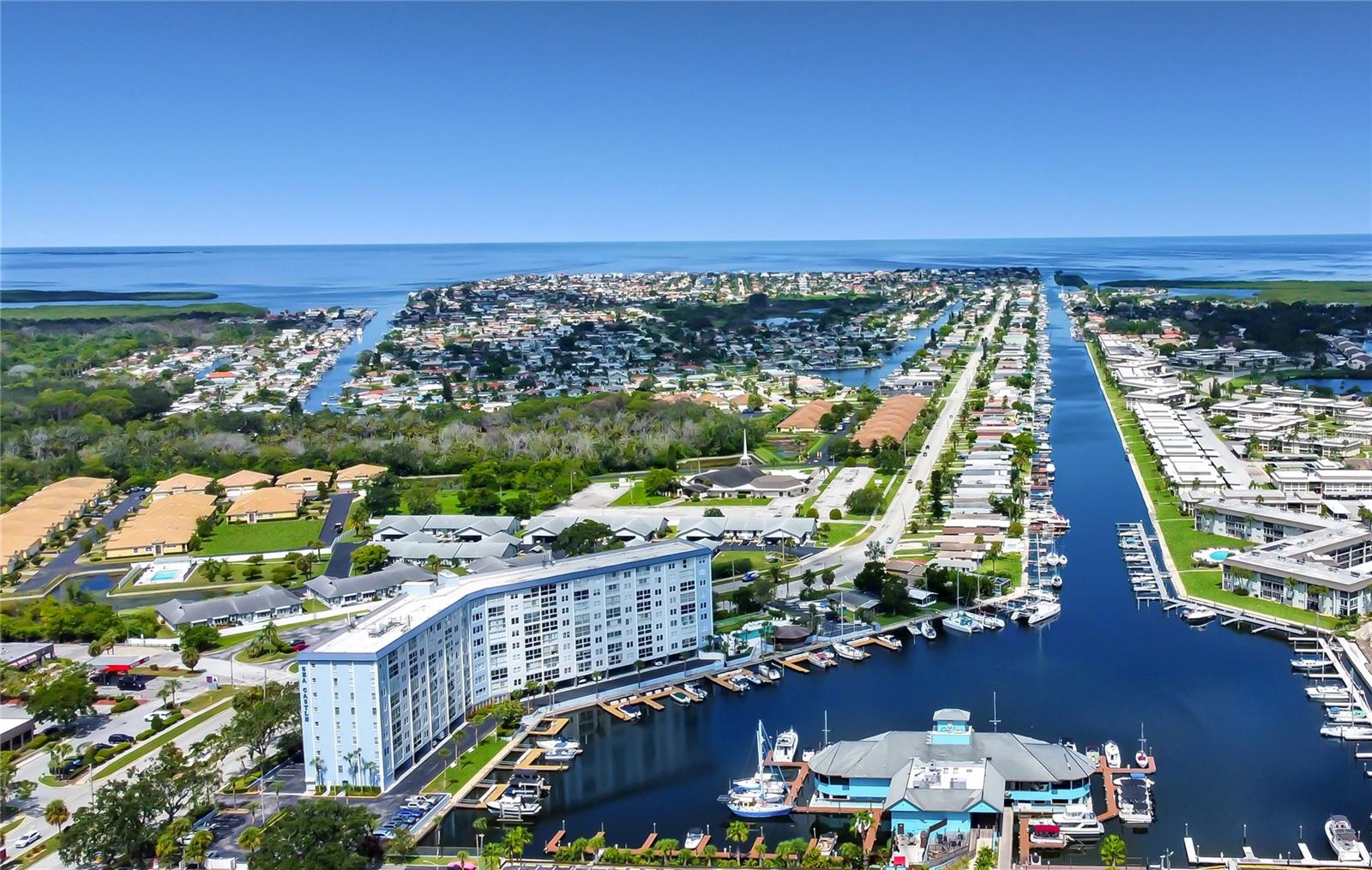 WATERFRONT CONDO – Live the Ultimate Florida Lifestyle! Don’t miss this incredible opportunity to own a 1-bedroom, 1-bathroom waterfront condominium in the highly desirable Sea Castle community of Gulf Harbors. This light and bright unit features a spacious open floor plan and floor-to-ceiling windows that provide unobstructed water views the moment you walk in. Imagine starting your day sipping coffee by the windows while watching boats sail by and dolphins or manatees at play. This unit offers a rare chance to customize the interior to your own tastes—skip the cost of someone else’s remodel and make it your own! Community Features Include: -Oversized heated waterfront pool -BBQ grills and large gazebo for entertaining -Shuffleboard -Fishing areas and marina access (boat slips periodically for sale or rent) -Workshop space for hobbyists and DIYers. As a resident, you’ll have the option to join the exclusive Gulf Harbors Beach Club for just $200/year perfect for enjoying Florida’s famous sunshine, soft sand, swimming and breathtaking sunsets. Additional Highlights: -Located near Downtown New Port Richey, home to popular restaurants, bars, and entertainment -Close proximity to shopping and top-rated medical facilities. Whether you’re looking for a full-time residence, a vacation getaway, or a savvy investment, this condo delivers the perfect blend of lifestyle and location. Come see why living at Sea Castle is the best-kept secret in New Port Richey! (Includes 2 STORAGE UNITS) Call today for more information!
