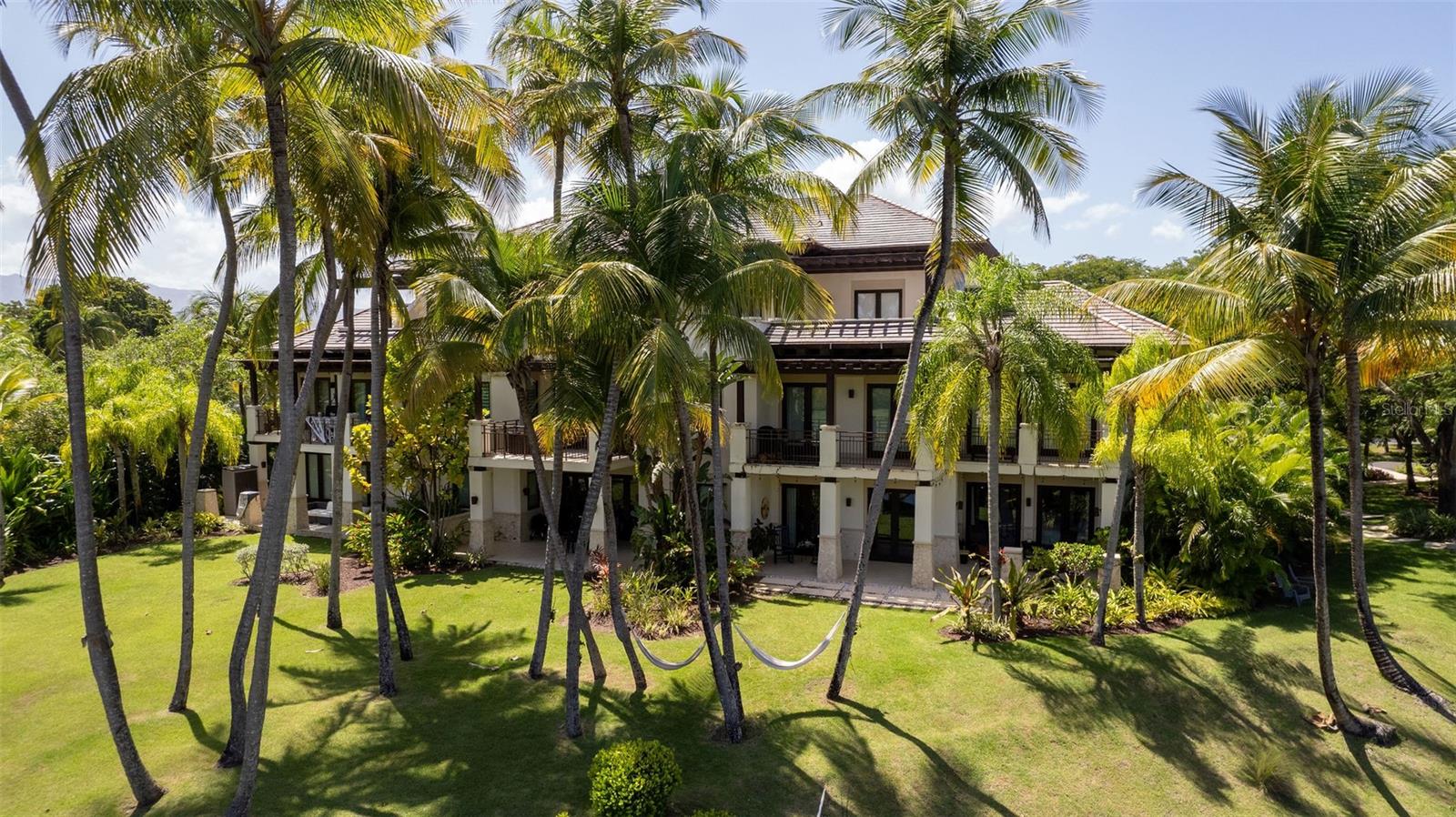Welcome to Las Verandas, a stunning retreat located within the prestigious Bahia Beach Resort. This beautifully appointed apartment features two elegantly designed bedrooms, each showcasing unique floral and palm-themed wallpaper that brings the lush tropical landscape indoors. The sophisticated decor, coupled with natural light flooding through large windows, creates a serene atmosphere perfect for relaxation. Step out onto the private balcony to enjoy your morning coffee amidst the gentle breeze and lush surroundings.
The heart of this apartment lies in its spacious open-plan living and dining area, seamlessly connecting to a modern kitchen equipped with high-end appliances and sleek cabinetry. Ideal for entertaining, the living space is designed for both comfort and style, featuring ample seating and elegant touches throughout. Guests enjoy exclusive access to the resort's amenities, from pristine swimming pools to direct beach access, ensuring a luxurious and memorable stay. Experience the ultimate in resort living at Las Verandas, where every detail is crafted for your comfort and enjoyment.