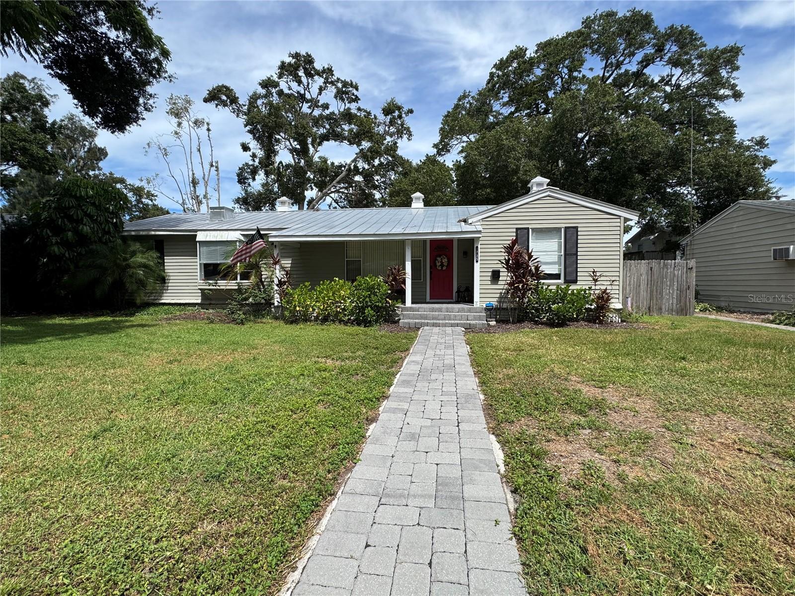 One or more photo(s) has been virtually staged. Charming and Spacious Home in Prime St. Pete Location Non-Flood Zone, Move-In Ready, Huge Lot. Welcome to this spacious 3-bedroom, 2-bath home located in the highly desirable area of St. Petersburg. Perfectly positioned just minutes from downtown and with quick highway access, this home offers both convenience and proximity to the pulse of the city. Step inside to discover a light-filled open floor plan with modern finishes and over 2,100 square feet of living space. Luxury vinyl plank (wood look) flooring flows throughout the home, creating a warm and cohesive feel paired with easy maintenance and cleaning. The kitchen is a true highlight—featuring granite countertops, all-wood cabinetry with crown molding, and stainless steel appliances—ideal for both entertaining and everyday life. It sits in the middle of an open and welcoming floorplan. The spacious primary suite offers a peaceful retreat with a private en-suite bath and walk-in closet. There are two additional bedrooms and an additional bathroom, featuring dual vanity. Some notable features include: 2,117 SF of living space on one level, a fully fenced oversized 1.5x lot, a large paver driveway (off the alley) could fit 4+ cars, a 2019 HVAC system and 2014 metal roof, front and back covered porches for year-round outdoor enjoyment, a large attached storage shed, and full indoor laundry room with appliances. No flooding from Hurricanes Helene or Milton in 2024 (home is more than 50 feet above sea level). Flexible living space includes both a formal sitting area and a cozy lounge—perfect for entertaining, relaxing, or working from home. The home’s layout offers comfort, privacy, and flow. You could live just minutes from Crescent Lake Park, local shops, major retail chains, restaurants, major hospitals, beaches, and downtown St. Pete. With easy access to I-275, both St. Pete/Clearwater and Tampa International airports are accessible. All information provided in this listing is deemed accurate, but buyer should conduct buyer's own due diligence to confirm the veracity of the same for buyer's purposes. One or more photo(s) has been virtually staged