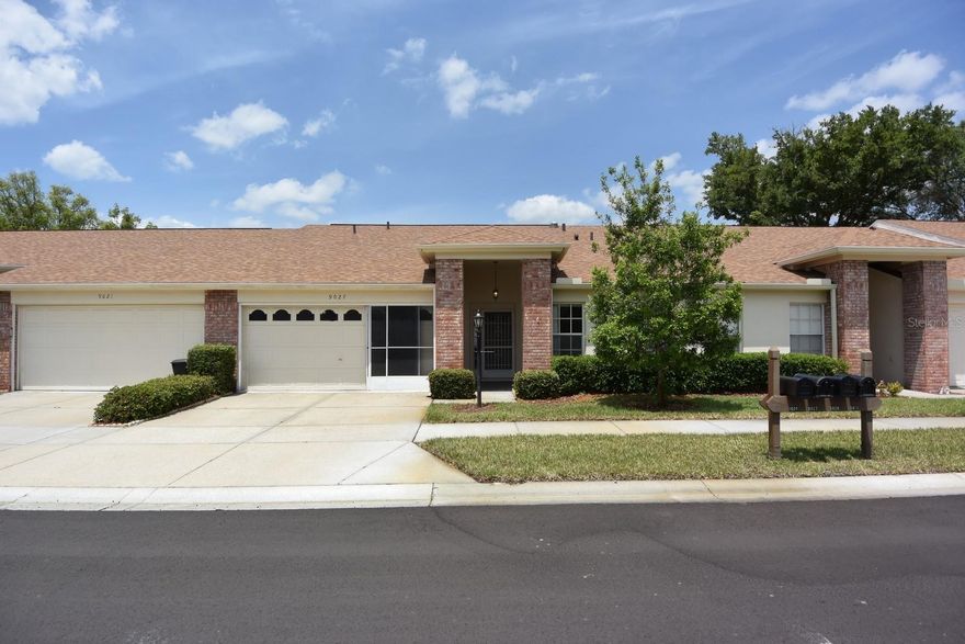 One or more photo(s) has been virtually staged. Welcome home to the desirable Two Cambridge Commons condominium complex within the beautiful Heritage Lake community of New Port Richey. This well-maintained 2-bedroom, 2-bath, 2-car garage condo features an open floor plan with beautiful laminate flooring, a desirable split-bedroom layout, and a bright and airy sunroom that provides the perfect space to relax and enjoy Florida living. The open patio offers additional outdoor enjoyment and is ideal for morning coffee or evening gatherings. Heritage Lake is a vibrant and active 55+ community offering an abundance of amenities, including a heated pool and spa, clubhouse, fitness center, library, billiards room, shuffleboard courts, tennis and pickleball courts, and a full calendar of social activities and events. Conveniently located near shopping, restaurants, medical facilities, golf courses, parks, and the Gulf Coast's beautiful beaches, this home offers the perfect combination of comfort, convenience, and an active Florida lifestyle. Don't miss your opportunity to enjoy maintenance-free living in one of New Port Richey's most sought-after adult communities. This property may qualify for Seller Financing (Vendee).