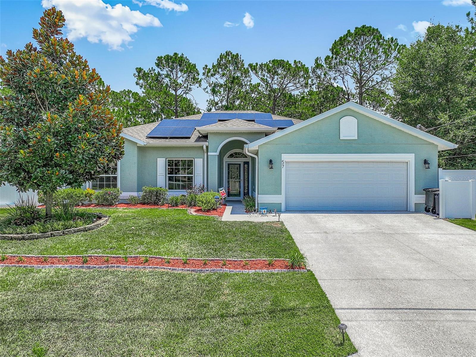 Located in a neighborhood known for its peaceful atmosphere and convenient access to local amenities, this meticulously maintained 3-bedroom, 2-bathroom home, built in 2019, offers a perfect blend of modern efficiency and thoughtful upgrades. The home is equipped with owned solar panels and a whole-house generator powered by two propane tanks, providing energy efficiency and reliable backup power for year-round comfort and security. Inside you'll find a bright and airy layout featuring planation shutters on all windows-excluding the sliding glass door-offering both style and privacy. Hurricane shutters add an extra layer of protection during storm season. The screened in back porch and extended paver patio creates an ideal space for relaxing or entertaining outdoors, while the fully fenced yard with privacy fencing ensures seclusion and peace of mind. Additional exterior features include an irrigation well for easy landscaping maintenance, a sturdy shed for extra storage, and gutters with gutter guards to help keep the homes exterior in pristine condition. For eco-conscious buyers, the garage is outfitted with an electric vehicle charger, making this home not just beautiful, but also future-ready! The laundry room includes a utility sink and the garage includes a garage door screen to add open air as you work in the workshop area. From its efficient systems to its stylish finishes and outdoor upgrades, this home is a true gem in sought-after location.