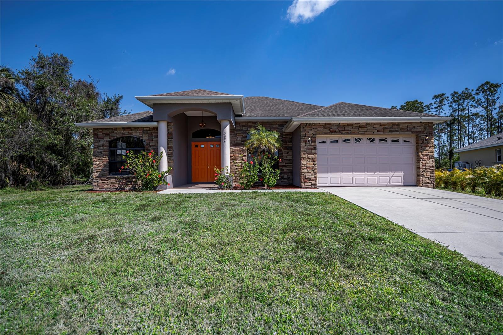 SELLER MAY ACCEPT YOUR HOME AS A PARTIAL TRADE!!! Nestled in North Port, this charming 2,142 sq. ft. 3 bedroom plus den, 2 bathrooms sanctuary welcomes you with its picturesque stone exterior, hinting at the warmth and character found within. Set on a sprawling 42 acre lot (80% larger than the neighborhood average), the expansive grounds offer ample space for outdoor activities or simply basking in the tranquility of nature. Step inside the newly updated home, where natural sunlight streams through the windows, illuminating the spacious living area and highlighting the exquisite details of the tray ceilings. Quality LVP flooring throughout, except for the tiled kitchen and bathrooms. The office/den provides a cozy retreat for quiet moments of relaxation or productivity. The kitchen beckons with its quartz countertops, stainless steel appliances, and abundant storage. Whether you enjoy the serenity of the outdoors or the comforts of indoor living, this home offers a harmonious blend of elegance and functionality. Seller may accept your current home as a partial trade.