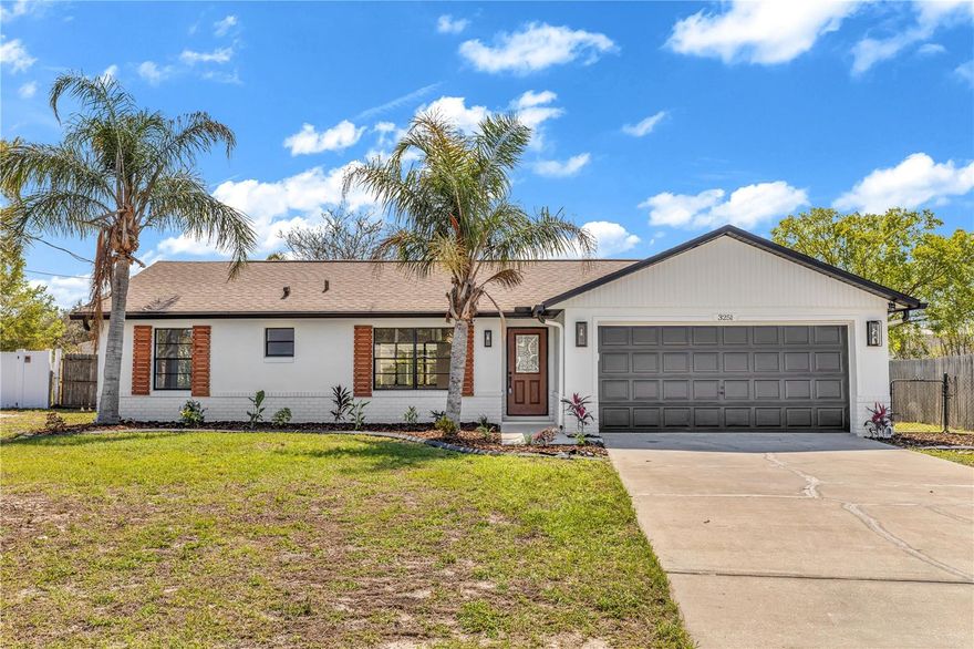 This beautifully remodeled 3-bedroom, 2-bath home is move-in ready and located in the desirable Deltona Lakes community. The upgraded kitchen features wood cabinetry, stainless steel appliances, and modern countertops, offering both style and functionality. The living room showcases a stunning travertine ethanol fireplace with under-mount lighting, creating a warm and inviting ambiance. Roof was replaced in 2023. NO HOA. Enjoy outdoor living in the oversized screened-in porch overlooking a fenced backyard—excellent for relaxing or entertaining. Conveniently located short distance to shopping, dining, and everyday amenities, this home is in a great neighborhood and won’t last long.