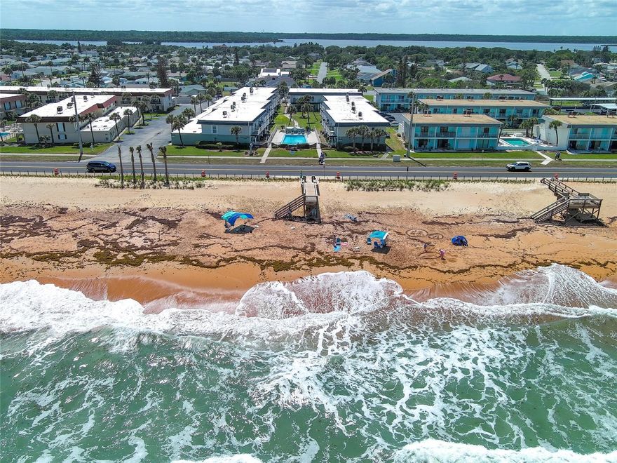 Life is better at the beach!!  Adorable 2 BR, 2 Bath townhouse style condo just across the street from the Beach!  Attached oversized garage for your car, motorcycle, bikes, beach chairs & toys, & more!! Located in a quiet complex  just 5 miles north of the popular Granada Blvd, you have the best of both worlds!   Lots of restaurants & shopping, yet the tranquility of beach life.   Two story home has 1216 sq ft living area with a covered deck off the living room.   Living room/dining room combo, cute updated kitchen (hmmm...should you make dinner or reservations?!), gorgeous updated bathroom with walk in shower, all downstairs.   Both bedrooms upstairs.   Large master bedroom offers a brand new Trex balcony with ocean & pool views!  Private location towards the back of the complex, too.   All furnishings & decorations have a fun coastal vibe and are negotiable!  One month rentals allowed here so you could use it for your personal getaway part of the year & rent it out for a few months to help cover costs.  AC replaced 2023, newer hot water heater, too.   You'll have peace of mind to know that the condo reserves are good, special assessments have been paid, and the exterior of all buildings will be painted soon! Lots of parks & playgrounds near by for fishing, kayak & paddleboarding, playgrounds, brand new walkover to the beach.  Welcome home!