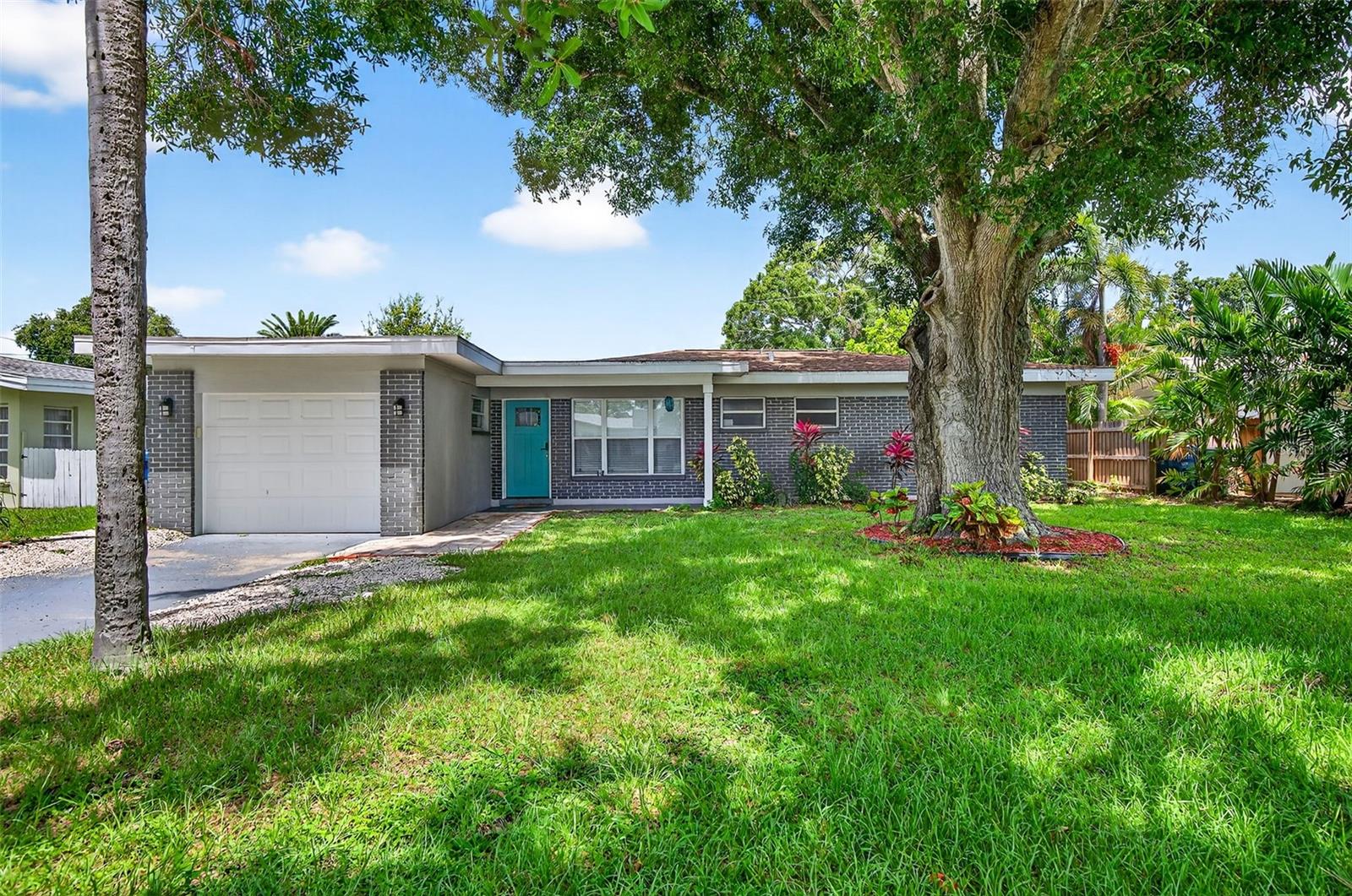 Charming 4-Bedroom 2-Bathroom Home in Central Largo – Updated Interior & Serene Setting. Welcome to this beautifully updated 4-bedroom, 2-bath home offering 1,432 sq ft of comfortable living space in a quiet, centrally located Largo neighborhood. Situated on a peaceful street with mature landscaping, this move-in ready home combines modern upgrades with classic charm. Step inside to discover an inviting open-concept layout featuring engineered hardwood flooring throughout and abundant natural light. The spacious living and dining areas flow effortlessly into the stunning kitchen, complete with granite countertops, white shaker cabinets, stainless steel appliances, and a stylish subway tile backsplash. The generously sized primary suite features walls of windows and a ceiling fan, while both bathrooms are tastefully renovated with modern tile work, updated vanities, and sleek fixtures. Additional highlights include a dedicated laundry room, fresh neutral paint, and a 1-car garage for added convenience. Enjoy the large, fully fenced backyard with a private patio area—perfect for entertaining or relaxing in the Florida sunshine. Located just minutes from beaches, parks, shopping, and dining, this home offers easy access to everything Largo has to offer. Don’t miss your chance to own this move-in ready gem in a desirable location!