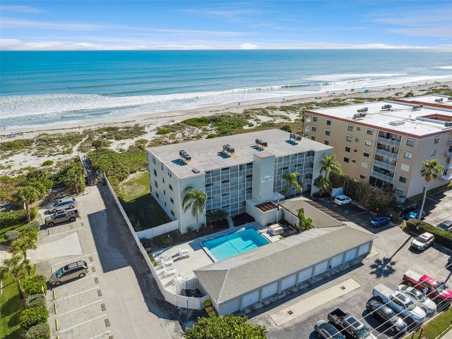 Wake up to endless Ocean Views and the soothing rhythm of the Atlantic in this direct Oceanfront 3-bedroom, 2-bath corner residence on Cocoa Beach. Perched on the fourth floor, this light-filled condo offers sweeping, unobstructed water views from every angle, all enjoyed from an expansive private balcony—perfect for sunrise coffee or sunset cocktails with ocean breezes. Designed for relaxed coastal living and effortless entertaining, the 2023 redesigned kitchen features new cabinetry, Granite countertops, a counter-height bar, and Stainless-Steel appliances with an open, inviting flow. The spacious primary suite is a true retreat, offering ocean views, balcony access, and abundant storage with a large walk-in plus an additional closet. Thoughtful upgrades throughout include tile flooring for easy care, hurricane-rated sliders, updated lighting, refreshed baths, in-unit washer and dryer, a new HVAC system and Water Heater (2024), and a newer front screen door. One-car garage provides ideal storage for beach gear and everyday convenience. The three-way split bedroom layout ensures privacy for family and guests alike. Offered fully furnished and truly turnkey, this home is ready for immediate enjoyment. The building has completed exterior with concrete restoration in 2024-25 including recent pool renovation. Milestone Inspection completed providing insurance safety as well. Whether you’re seeking a beachfront escape or a full-time coastal residence, this perfectly located oceanfront oasis delivers the lifestyle you’ve been dreaming of.