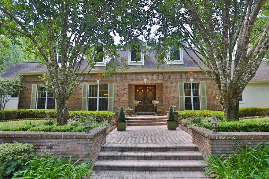 This incredible residence features beautiful gardens on 5 +/- acres in the equine-friendly gated community of Polo Lane.  Private tree-lined drive leads to a very elegant and comfortable traditional-style residence.  The 4 bedroom, 4.5 bath residence with 5,800 + SF offers a warm welcoming entry foyer leading to a lovely office, formal dining room, spacious family room featuring a fireplace, built-in entertainment center, and glass sliding doors leading to the charming outdoors.  The family room is open to the beverage bar, Chef's kitchen, and breakfast nook with large windows to enjoy the delightful views of the pool and gardens.  Split floor plan for added privacy.  Spacious Owner’s suite with glamourous bath featuring a steam shower.  Exercise room and an attractive stairway that leads to the second-floor entertaining area and media room.  Added bonuses are a KOI pond, putting green, a cabana with a fireplace and generous seating, and a generator for your peace of mind.  This truly a property offers something for everyone in the family.   Great location close to Publix, shopping, and medical facilities.