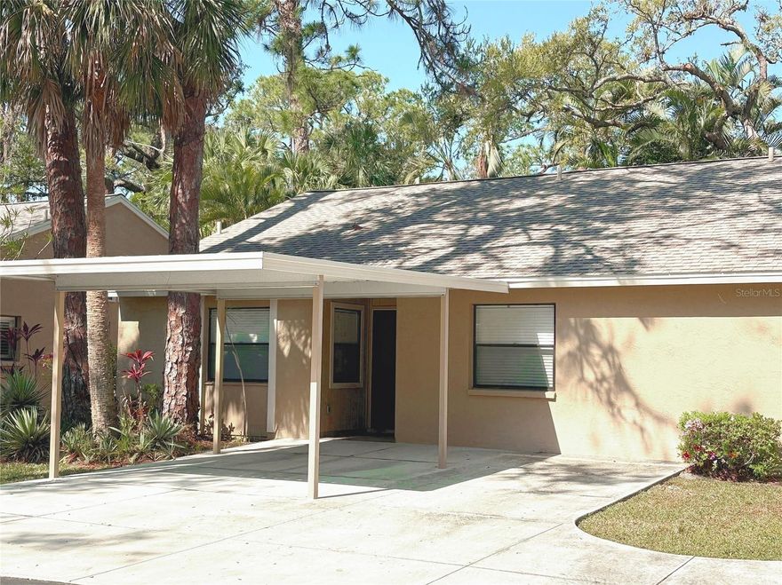 Looking for your home away from home? Take a look at this spacious light and bright one story villa located in fabulous Village Gardens, a pet friendly community, built on 13 acres in a lush tropical setting. Sold furnished (recliners not included) or can be empty at closing. Featuring 2 bedrooms, 2 baths, 1,197 sf, with a HUGE 17X13 eat-in kitchen with pantry, center island and lots of cabinets plus a laundry area; lovely enclosed lanai that beams in the Florida sunshine, with three remote-controlled shades and a 4th manual-controlled shade; L-shaped living & dining areas under a cathedral ceiling; large primary bedroom with large walk-in customized closet and & en-suite bath; guest bedroom with both a twin and double bed & hardly-used mattresses, a guest bath, concrete driveway with parking directly in front of the residence with one car carport and one additional parking space; For storage, there is an attic and an attached storage closet outside. HOA is responsible for costs to repair and replace roofs. Updates include: new roof and flat roof in 2015, A/C replaced in 2018 and is serviced twice/year; electric hot water tank in 2020; stove 2023; washer 2024; newer ceiling fans; pest control inspects 3 times/yr.  Max 2 pets allowed, weight limit is 40 lbs each and approval is required. Recycled water sprinkles grounds; Amenities include a clubhouse with library, kitchen for catering, social room, pool table, and manager's office; tennis court that doubles as pickleball ct; two shuffleboard cts; newly-surfaced heated pool and attached ramada with two gas grills; drive-through recycling area; and two car washing stations across from the pool. Village Gardens is a well-managed community and is located just minutes to downtown Sarasota, UTC Mall, Benderson Park, entertainment venues and restaurants.