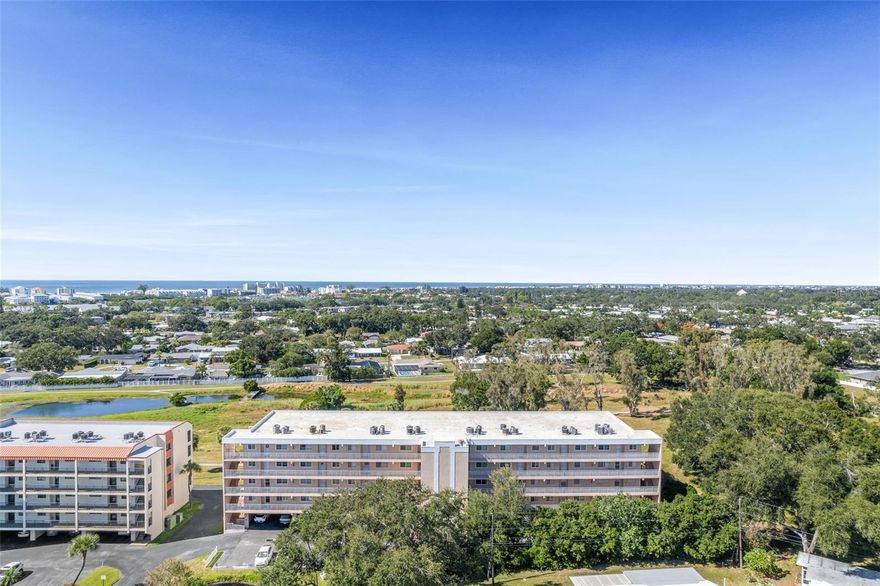 Enjoy coastal living just minutes from the beach in this spacious and fully furnished 2-bedroom, 2-bathroom condo at Harbor Greens, located at Yacht Club Estates Phase 2. This move-in ready home features an open kitchen with newer appliances, abundant cabinet and counter space, and inviting vinyl laminate flooring in the main living areas. Step onto your private 3rd floor balcony and take in peaceful views of the Baypoint Conservation Area. With a newer AC unit, hurricane windows, and a large storage closet, comfort and convenience come standard. The community offers an affordable HOA that covers almost everything except electricity and includes under-building assigned parking. Enjoy proximity to parks, shopping, and top-rated schools. Schedule your private tour and experience this inviting Seminole home today!