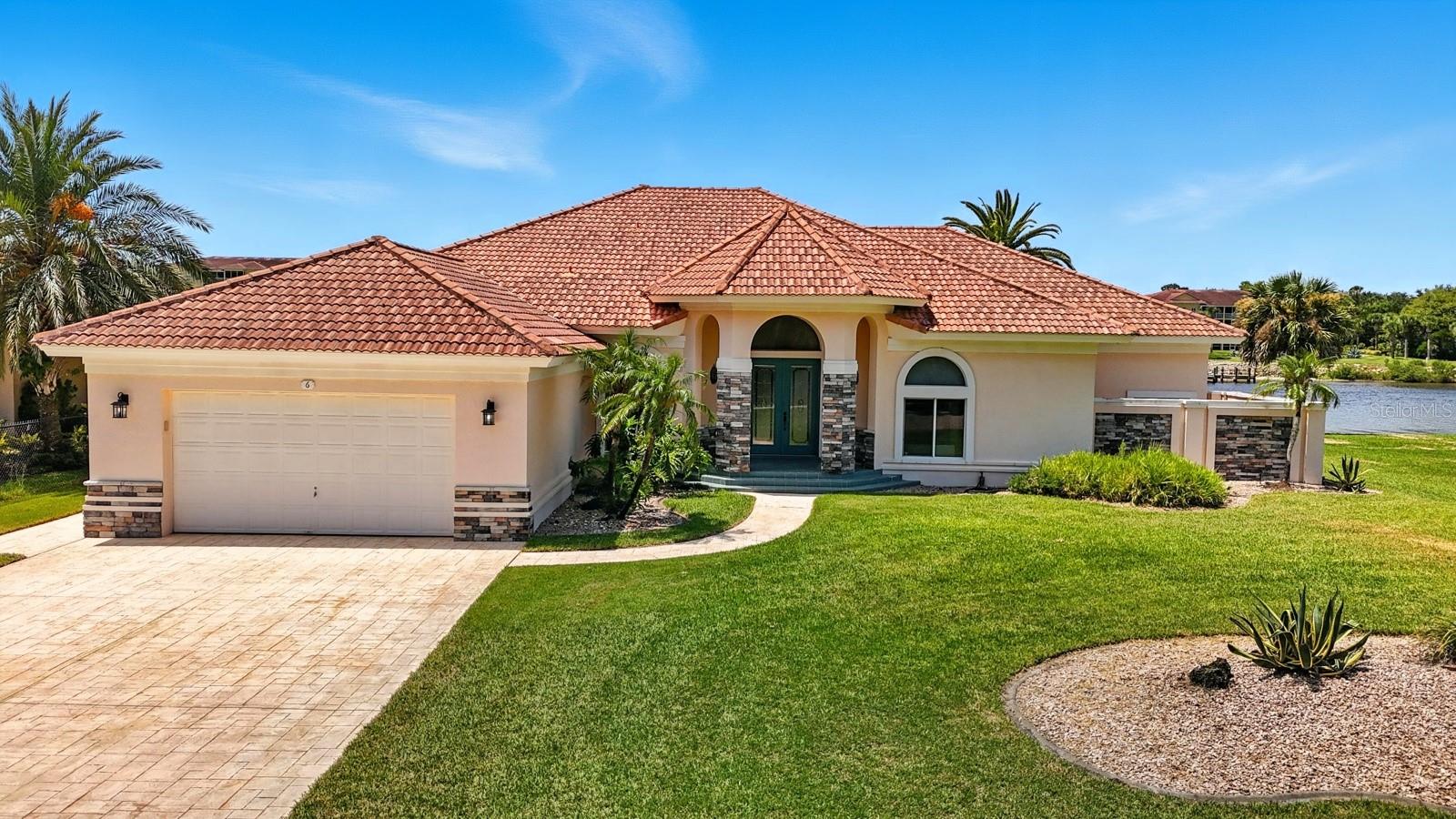 One or more photo(s) has been virtually staged. Welcome to your waterfront paradise! This exceptional custom-built intracoastal home in Bon Terra Estates offers 3,475 sq ft of living space with breathtaking views from the moment you step inside. The open living room features wall-to-wall sliding glass doors that flow seamlessly to a spacious screened patio overlooking the Intracoastal Waterway. Enjoy your private dock reinforced with cement pilings and a new 8,000 lb capacity boat lift, giving you secure access to deep water boating and endless coastal adventures. Inside, you'll find brand new appliances, a split-bedroom floor plan, a Florida room, a butler's pantry, a built-in bar, and a primary suite with a spa-like bath. Wake up to dolphins, manatees, and spectacular sunrises while sipping your morning coffee as boats pass along the Intracoastal. Built with concrete/stucco and a durable tile roof, this home has withstood hurricanes without flooding — a true blend of strength, elegance, and Florida waterfront living at its best.