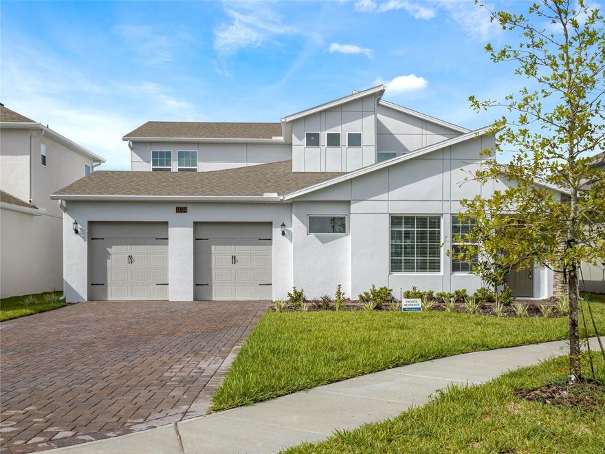 Welcome to this exceptional 5-bedroom, 5-bathroom residence in the highly sought-after Summerdale Park at Lake Nona, set on a private cul-de-sac with an extended driveway for up to 6 cars, a 3-car garage, a fenced backyard, and beautiful lake views. It also includes a private 1-bed/1-bath annex with closet—perfect as a dedicated home office or to provide independent living for a family member. The home showcases premium upgrades throughout. Enter through the main door into a private paved courtyard, perfect for outdoor relaxation, which connects to a convenient in-law suite complete with bedroom, full bath, and walk-in closet. Inside, the open living and dining areas boast soaring 20-foot ceilings and 10 oversized windows, creating a bright and luxurious atmosphere. The gourmet kitchen features 42” modern shaker cabinets, striking black quartz counters, a smoked glass backsplash, large sink, dishwasher, and refrigerator. The spacious primary suite on the main floor accommodates a California king plus seating, and includes a spa-like bath with dual sinks, wall-to-wall shower, and a large walk-in closet. Throughout the first level, stone-look ceramic flooring adds elegance and durability. A wide wood staircase leads to the upstairs loft/TV area with a wet bar, sink, cabinets, and beverage cooler—perfect for entertaining. The second floor also offers three additional bedrooms: two share a Jack-and-Jill bath, while the third has access to a full bath. Enjoy unforgettable sunsets from the covered lanai, overlooking the lake and fully fenced backyard, just 10 feet from the water’s edge. Community amenities include scenic walking paths, playgrounds, and a resort-style pool with cabanas. This lakefront gem combines modern design, comfort, and an unbeatable location—schedule your private tour today!